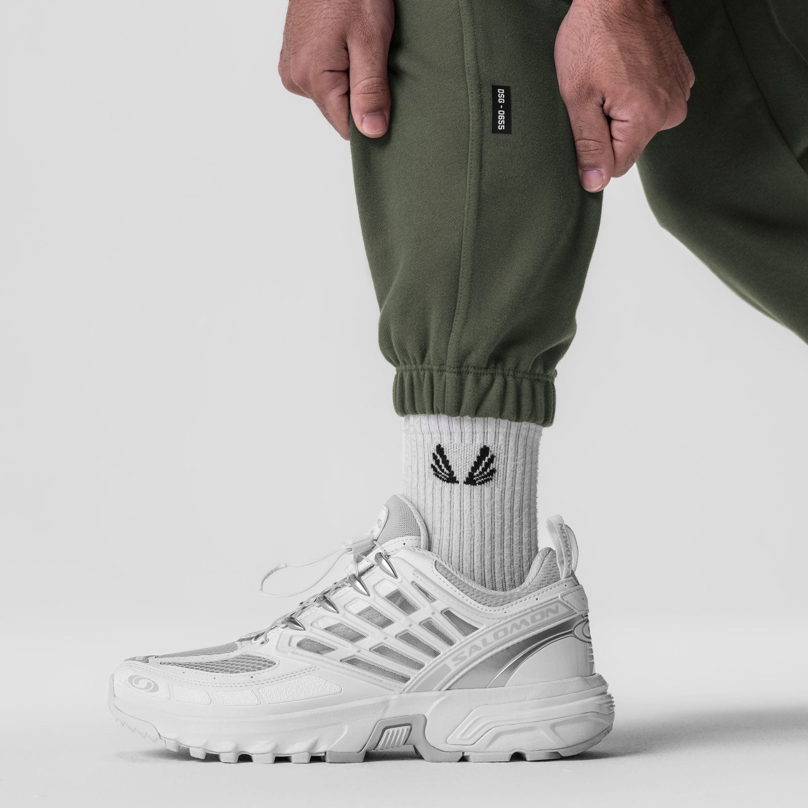 Tech-Terry Oversized Sweats in olive worn with white socks and sneakers, lower body detail