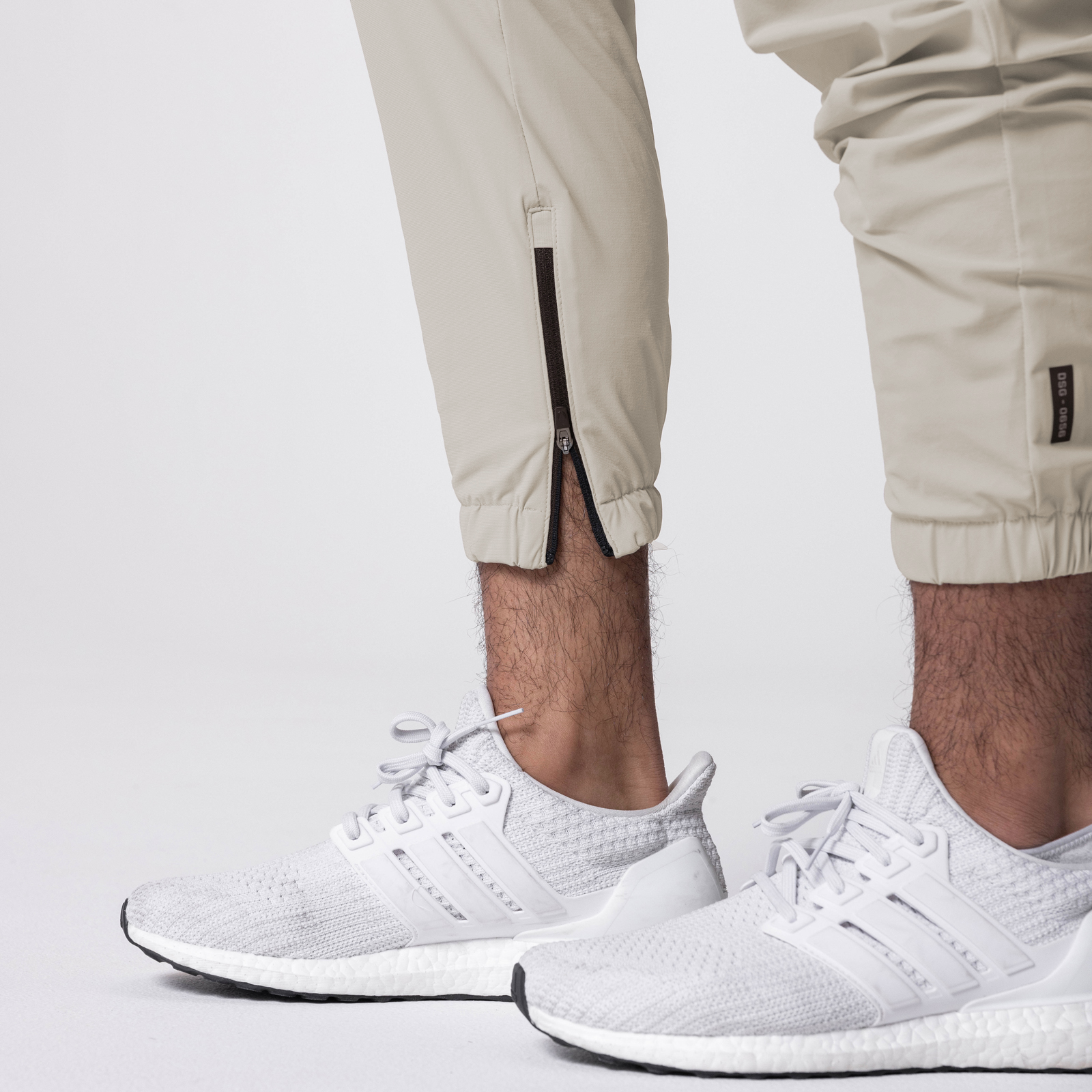 Tetra-Lite Standard Zip Jogger in sand smoke worn with white sneakers, front view