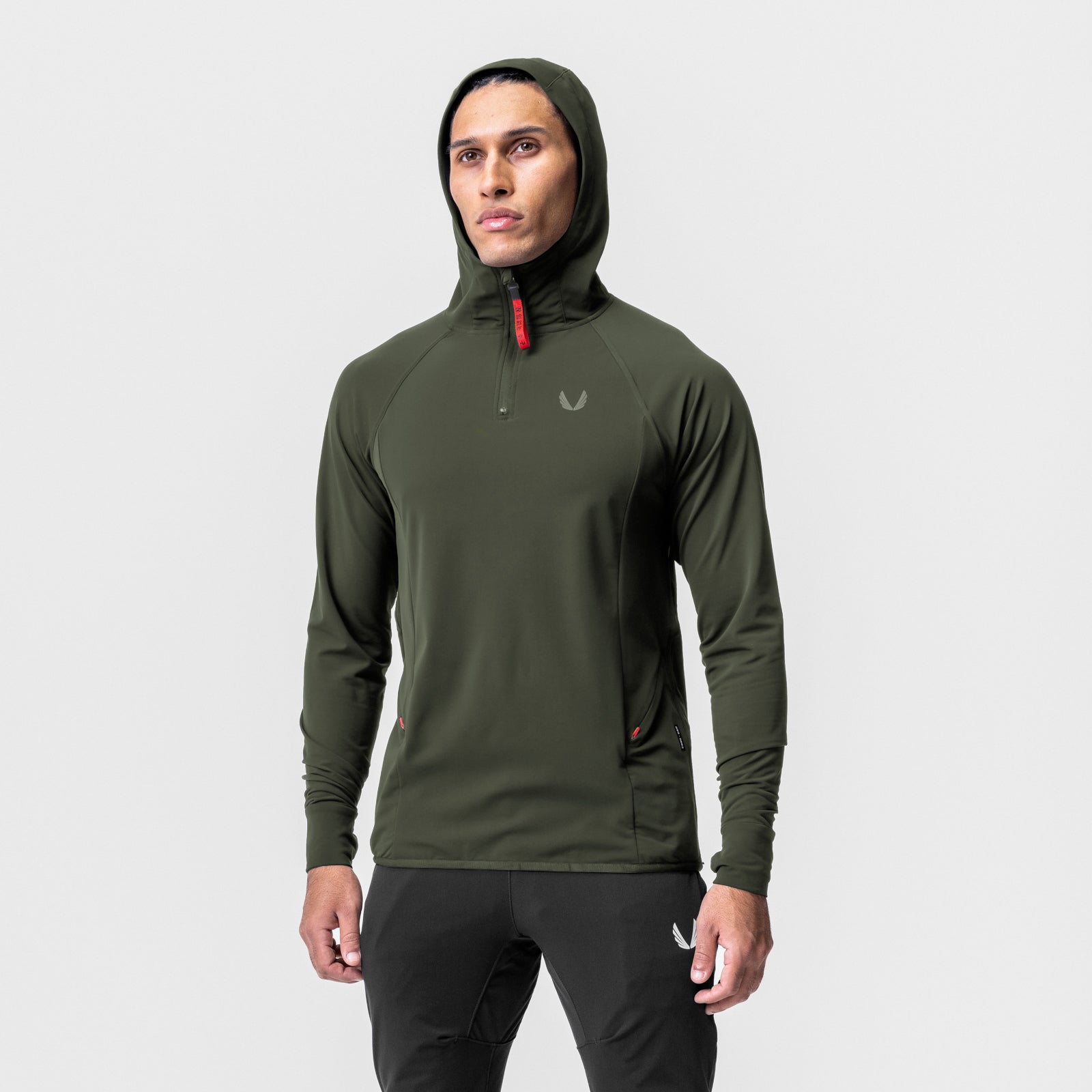 Training Hoodie in olive worn by model, front view with hood up