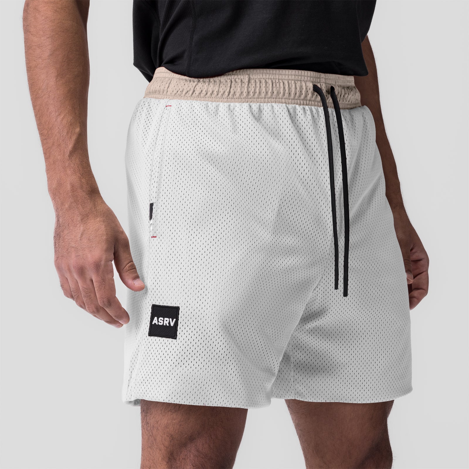 SilverPlus™ Mesh Reversible Short in beige and white, worn by model, side view