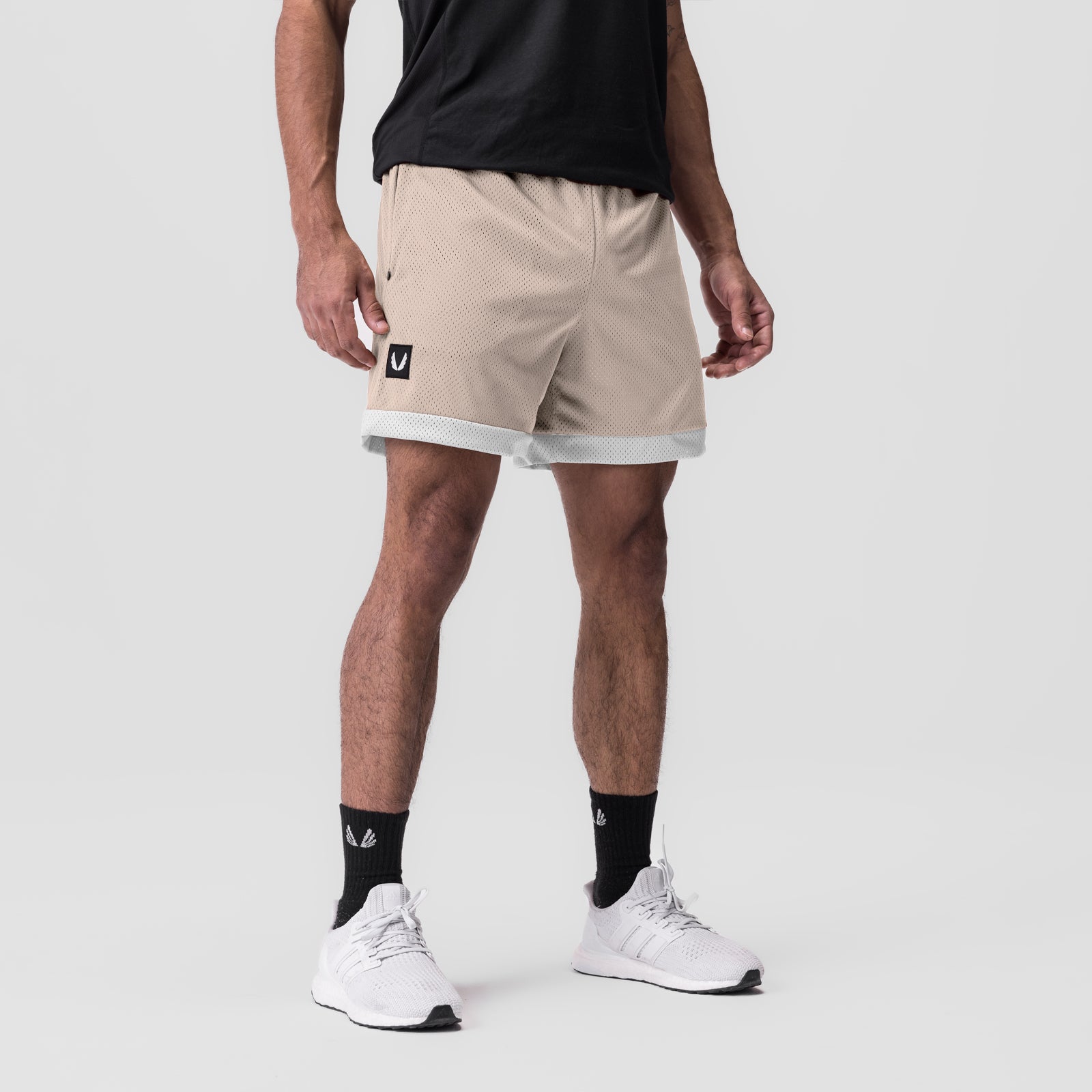 SilverPlus Mesh Reversible Short in beige with white trim, worn by model with white sneakers