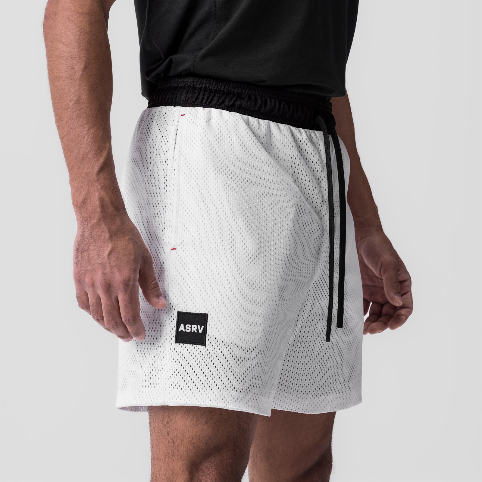 SilverPlus Mesh Reversible Short in white, worn by model, side view