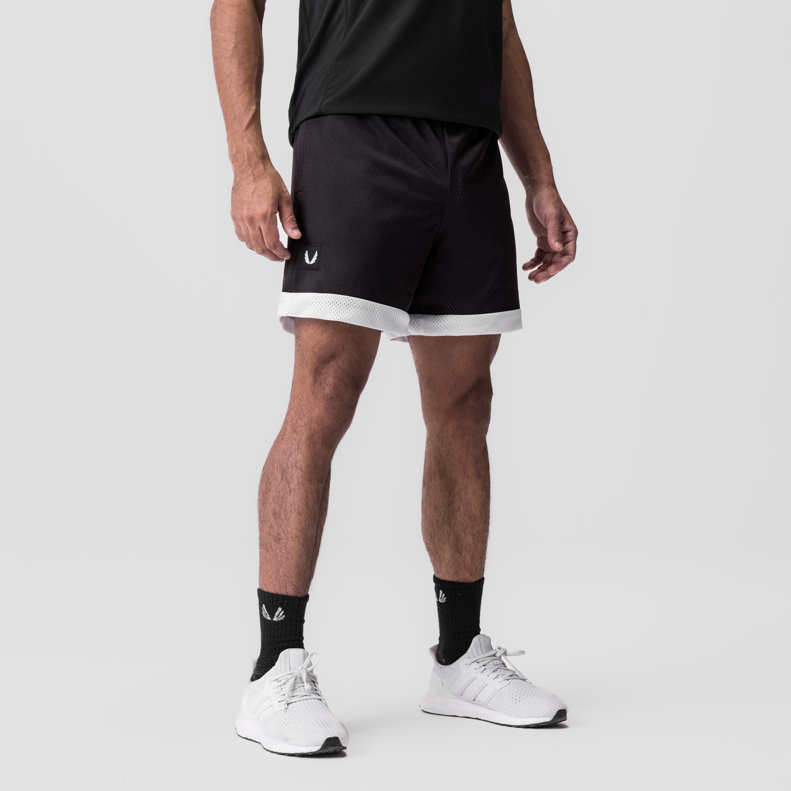 SilverPlus Mesh Reversible Short in black with white trim, worn by model, front view