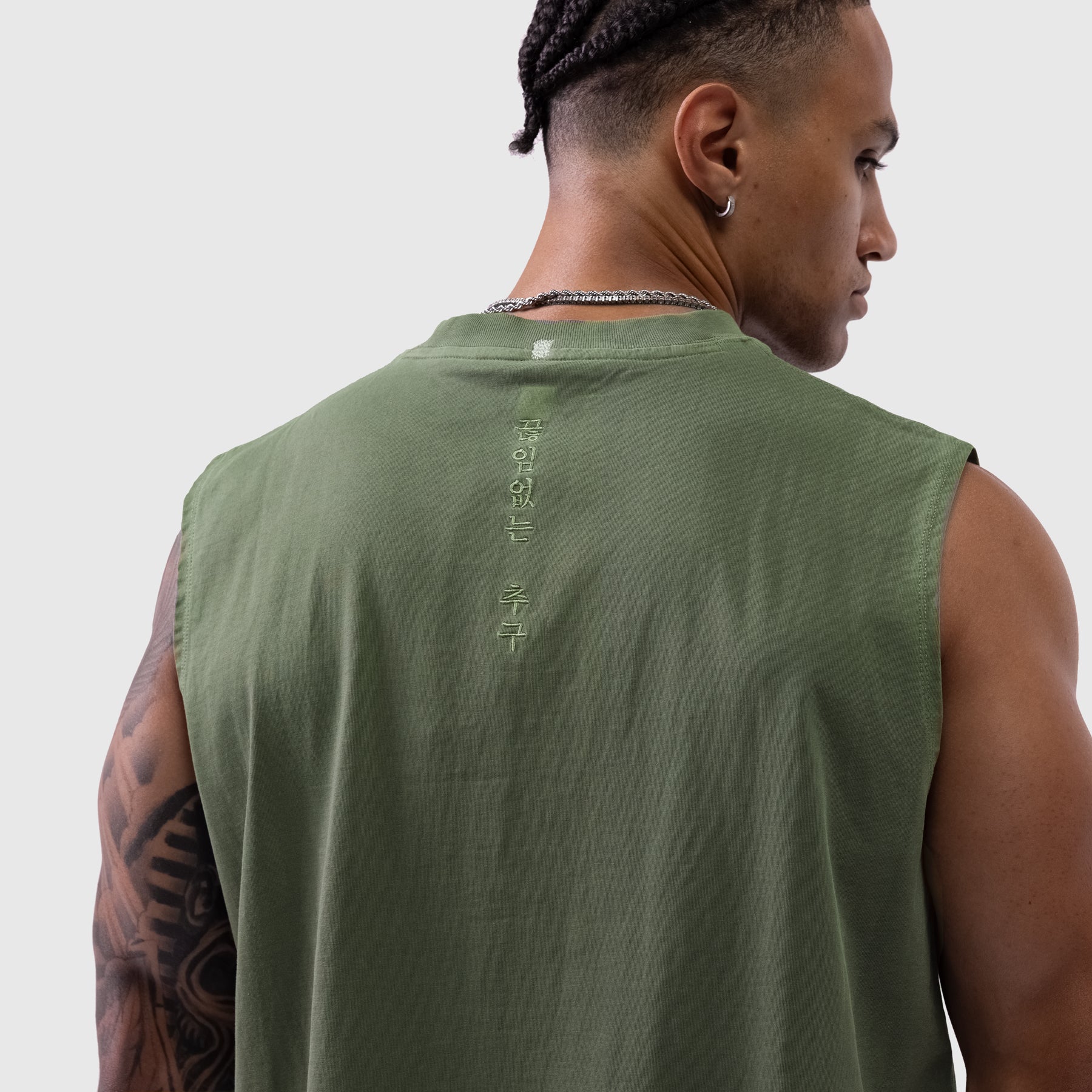 Tech Essential Relaxed Cutoff tank in faded olive, back view on model