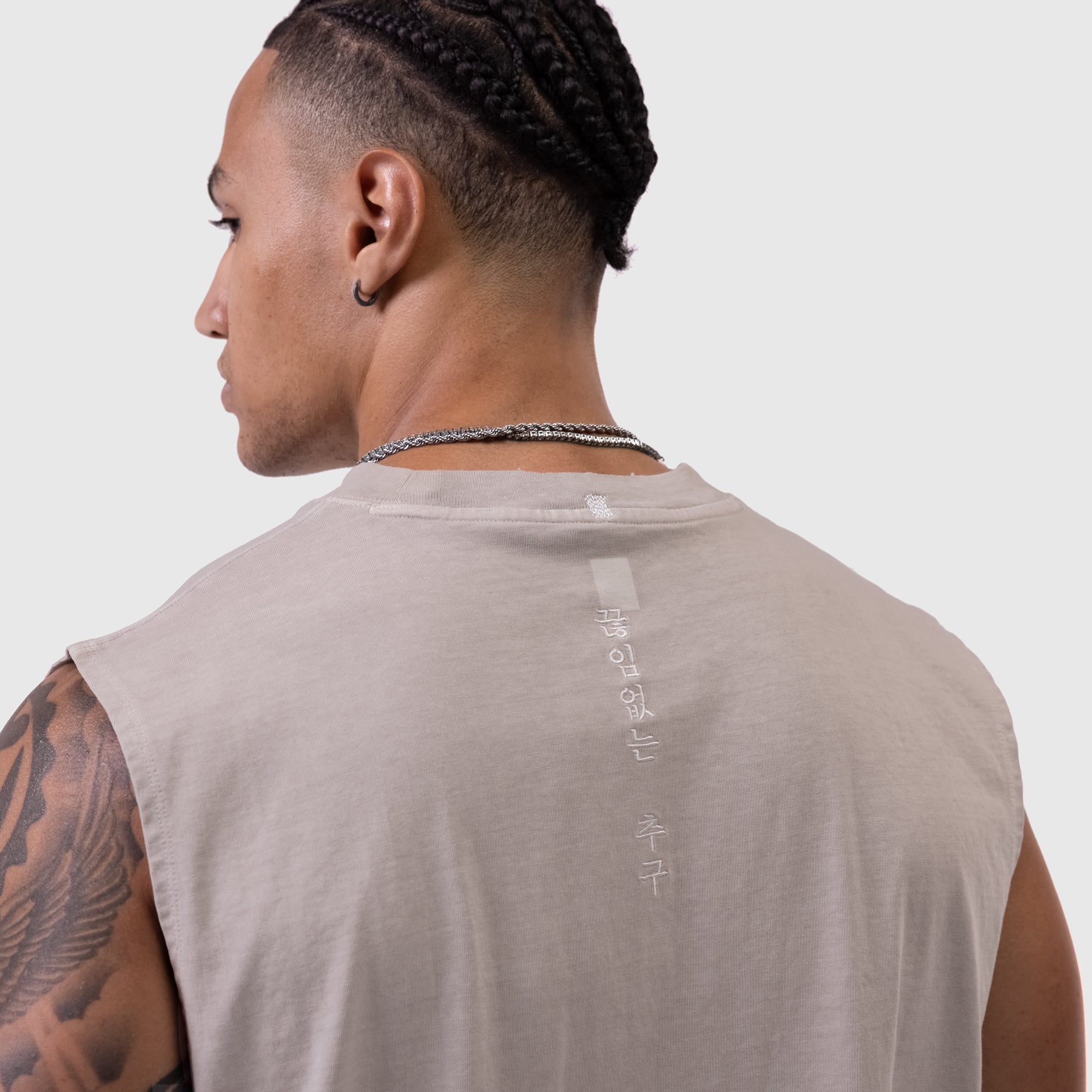 Tech Essential Relaxed Cutoff in Faded Chai, back view on model with tattoo
