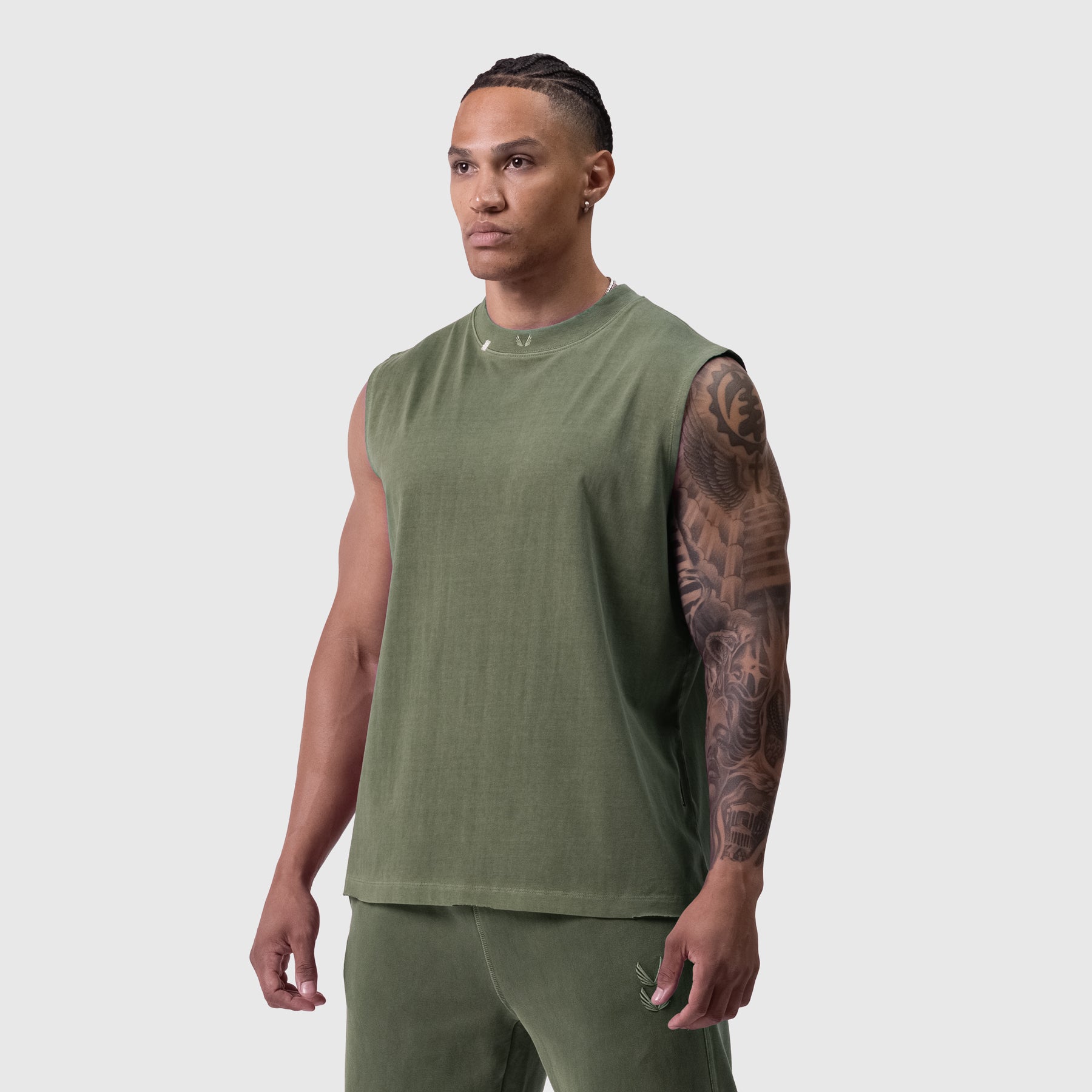 Tech Essential Relaxed Cutoff tank in faded olive, modeled front-facing