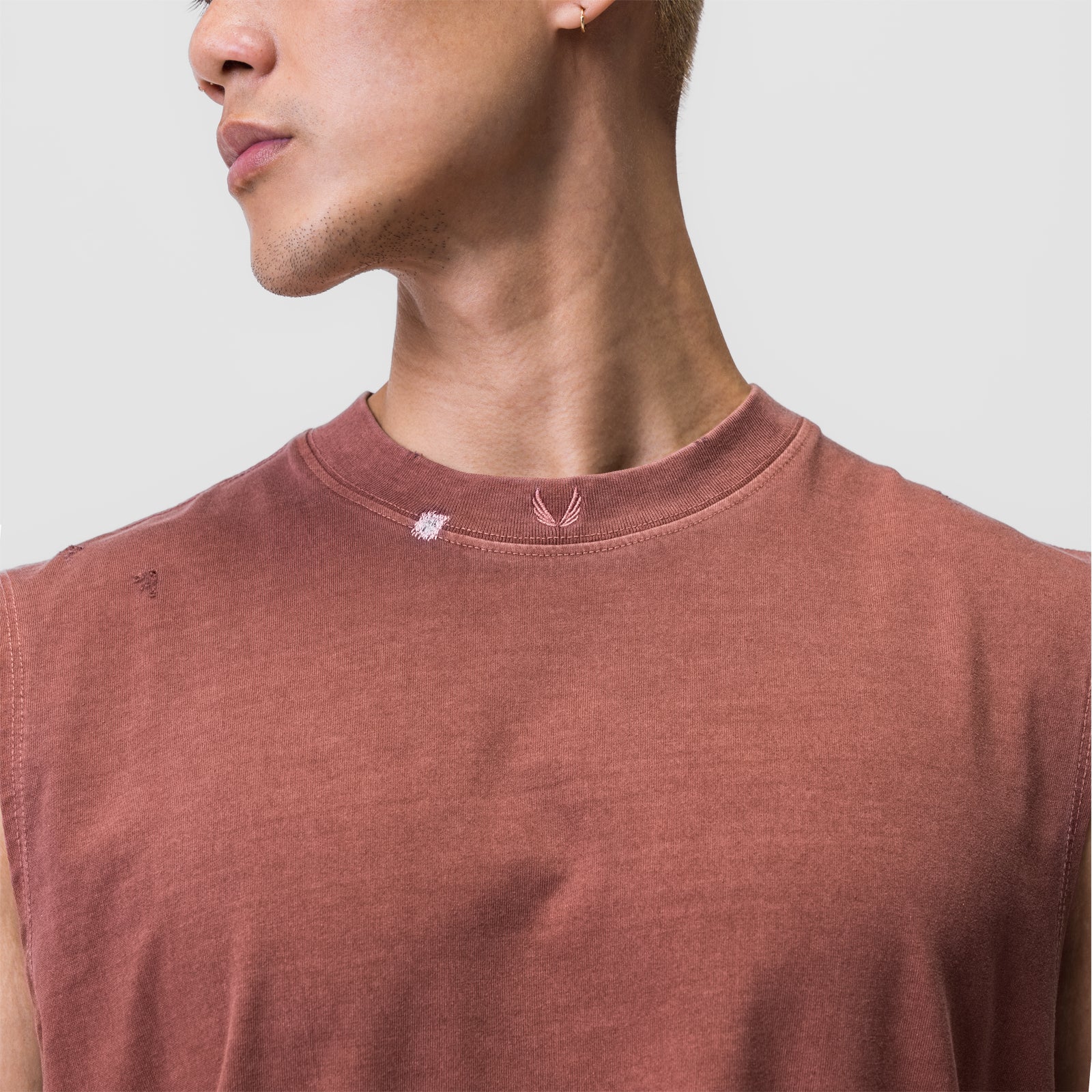 Tech Essential Relaxed Cutoff tee in faded brick, worn by model in profile view
