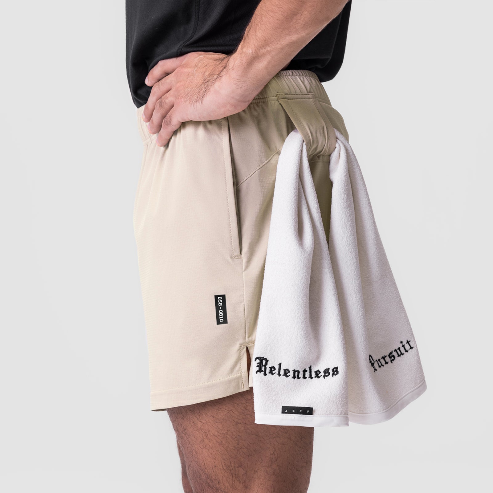 Ultralite 6" Linerless Short in beige worn by model, side view with white towel