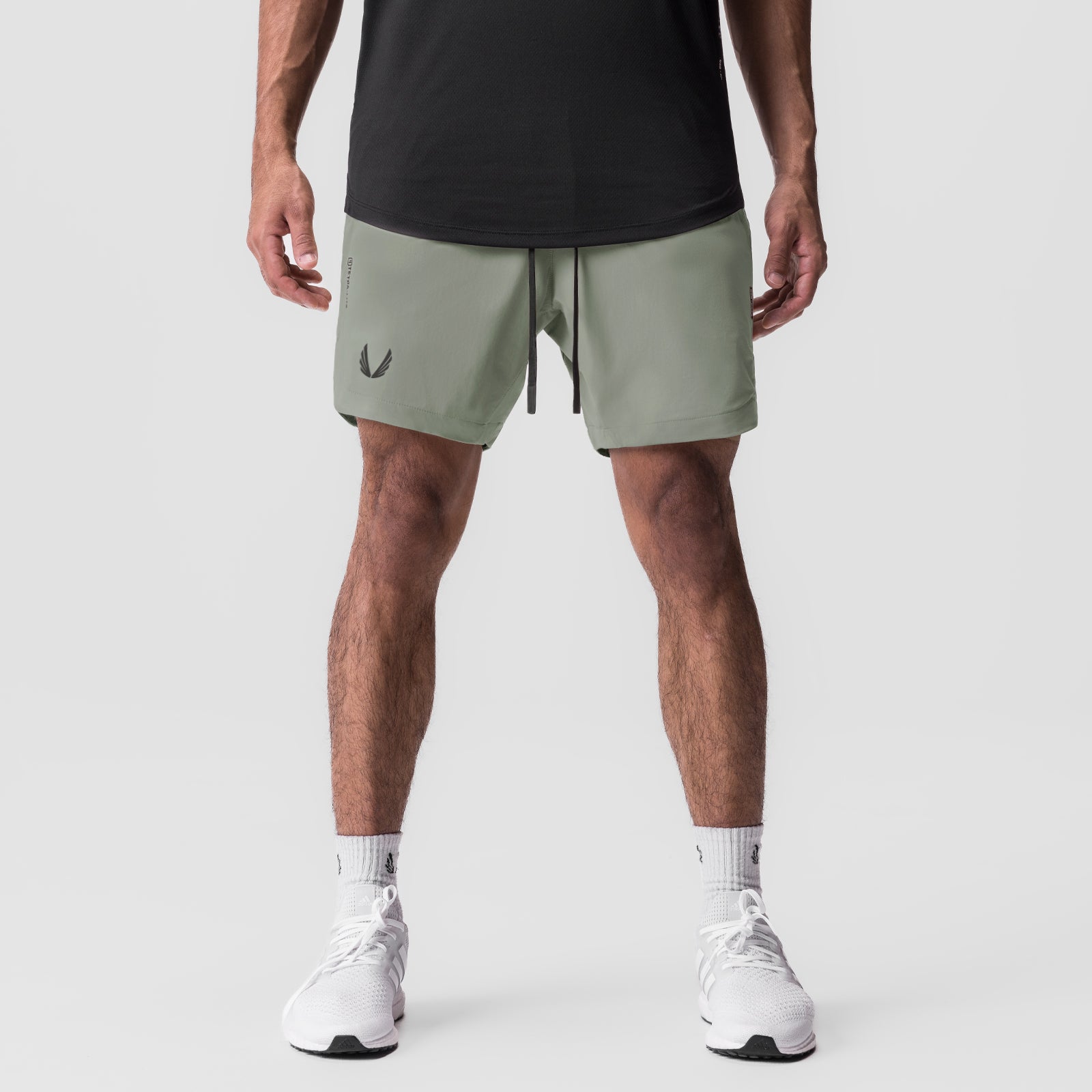 Tetra-Lite 7" Linerless Short in sage, modeled from front with white sneakers
