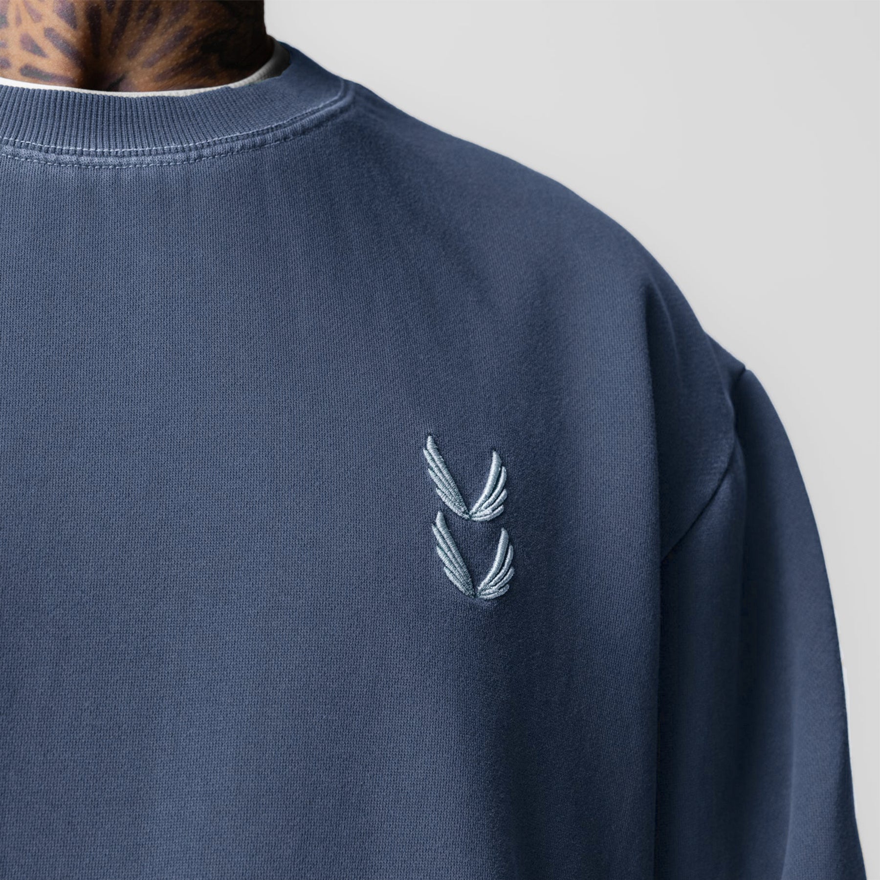 Tech Essential Distressed Crewneck in Faded Navy worn by model, chest detail view