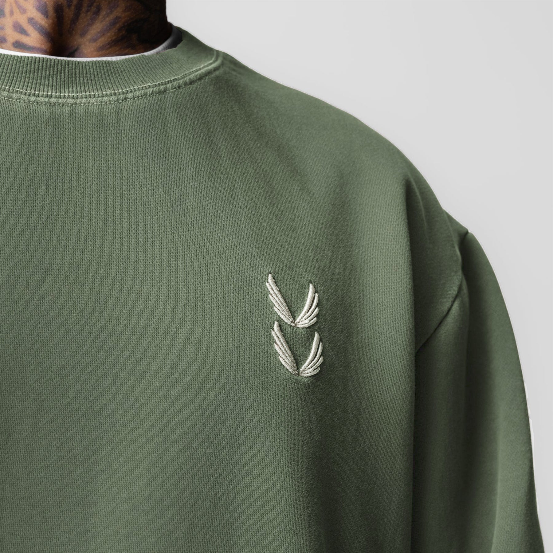 Tech Essential Distressed Crewneck in Faded Olive worn by model, close-up chest view