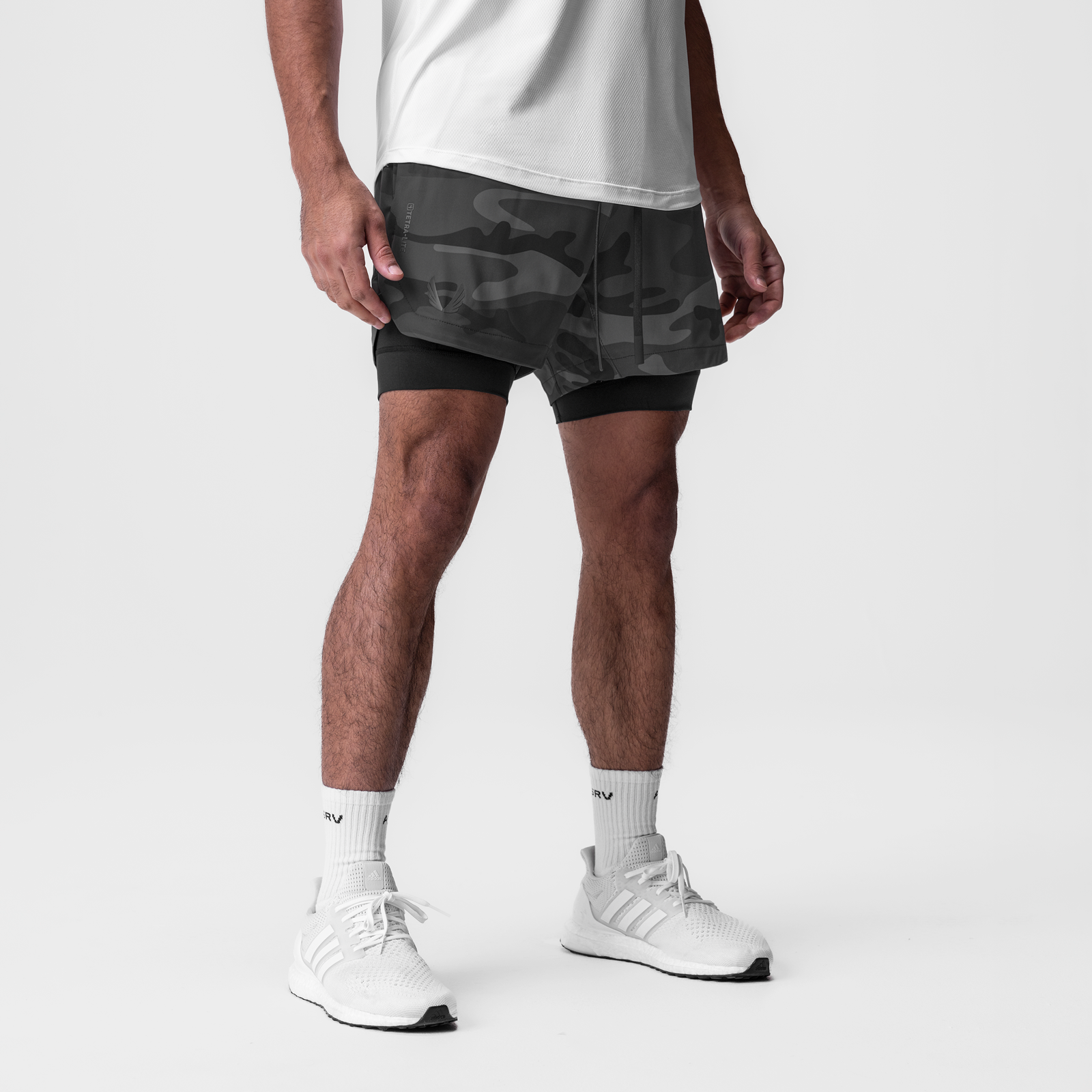 Tetra-Lite 7" Liner Short in black camo, modeled with white socks and sneakers