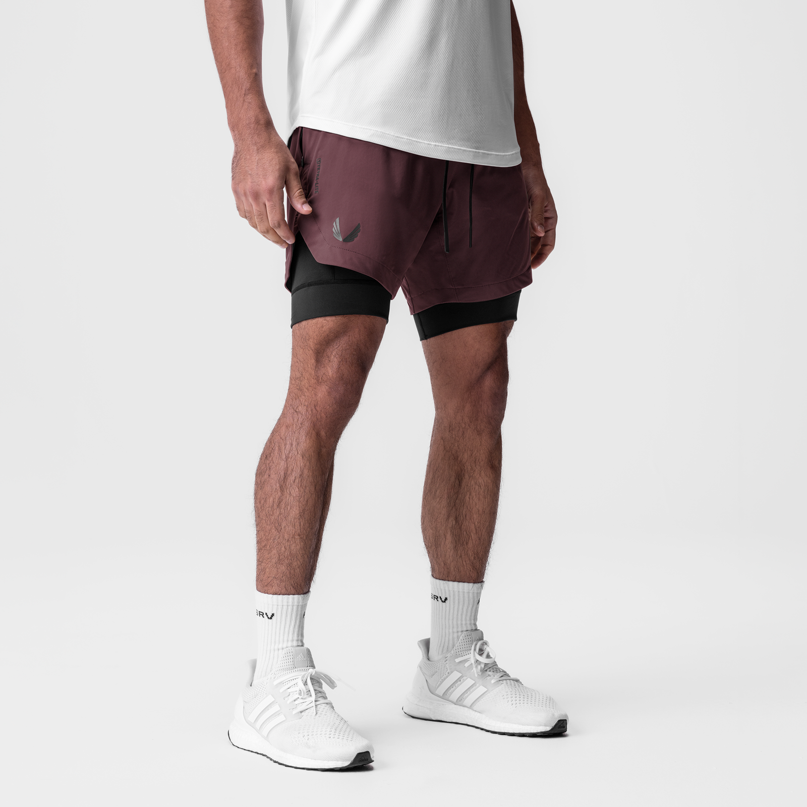 Tetra-Lite 7" Liner Short in Plum/Black worn with white sneakers and socks, side view