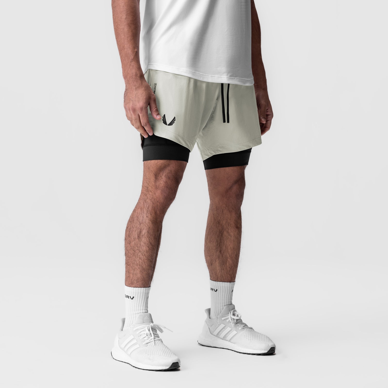 Tetra-Lite 7" Liner Short in Stone/Black, modeled with white socks and sneakers
