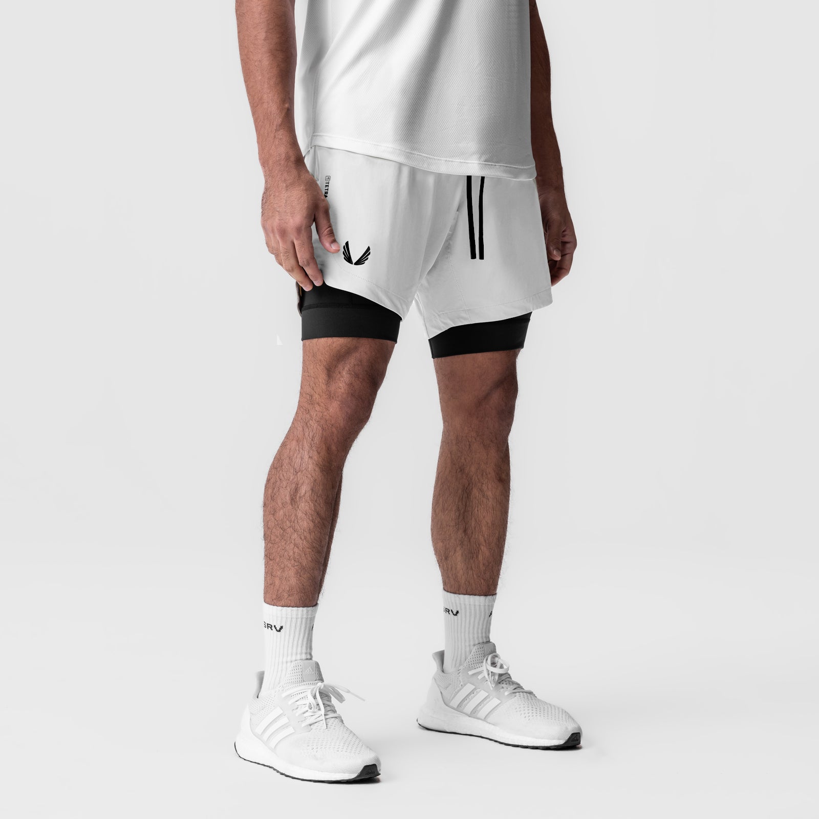 Tetra-Lite 7" Liner Short in white and black, worn by model with white socks and sneakers
