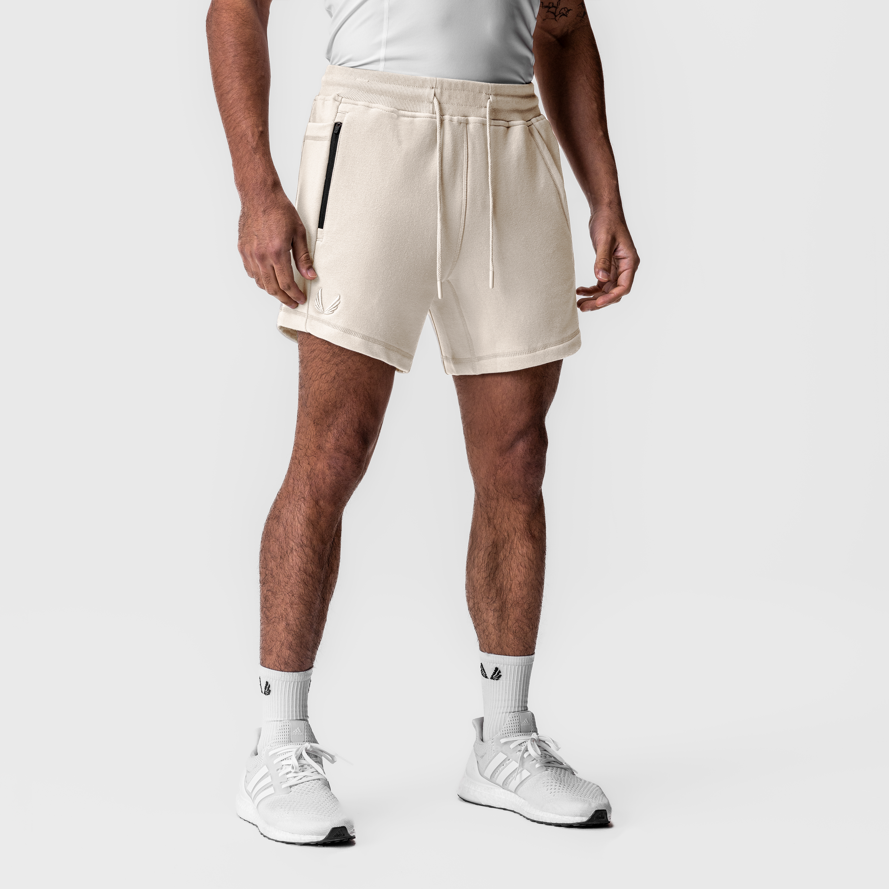 Tech-Terry Sidelock Sweat Short in ivory cream, worn by model with white sneakers