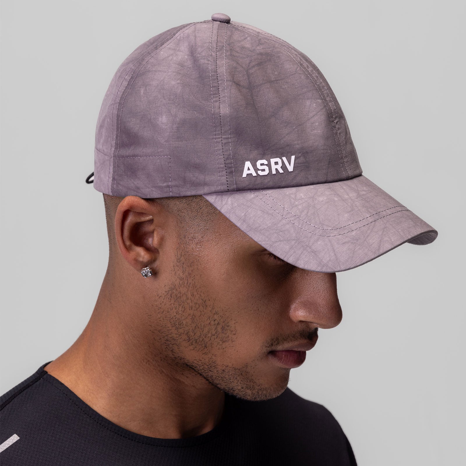 Weather-Ready Cinch Hat in purple wave dye, worn by model in side profile view