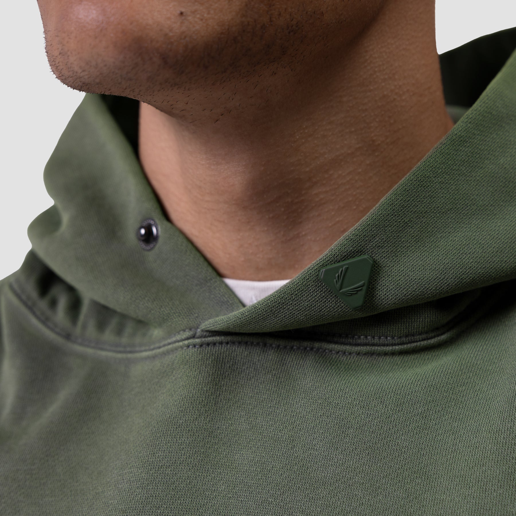 Tech Essential Distressed Hoodie in faded olive worn by model, detail view of neckline