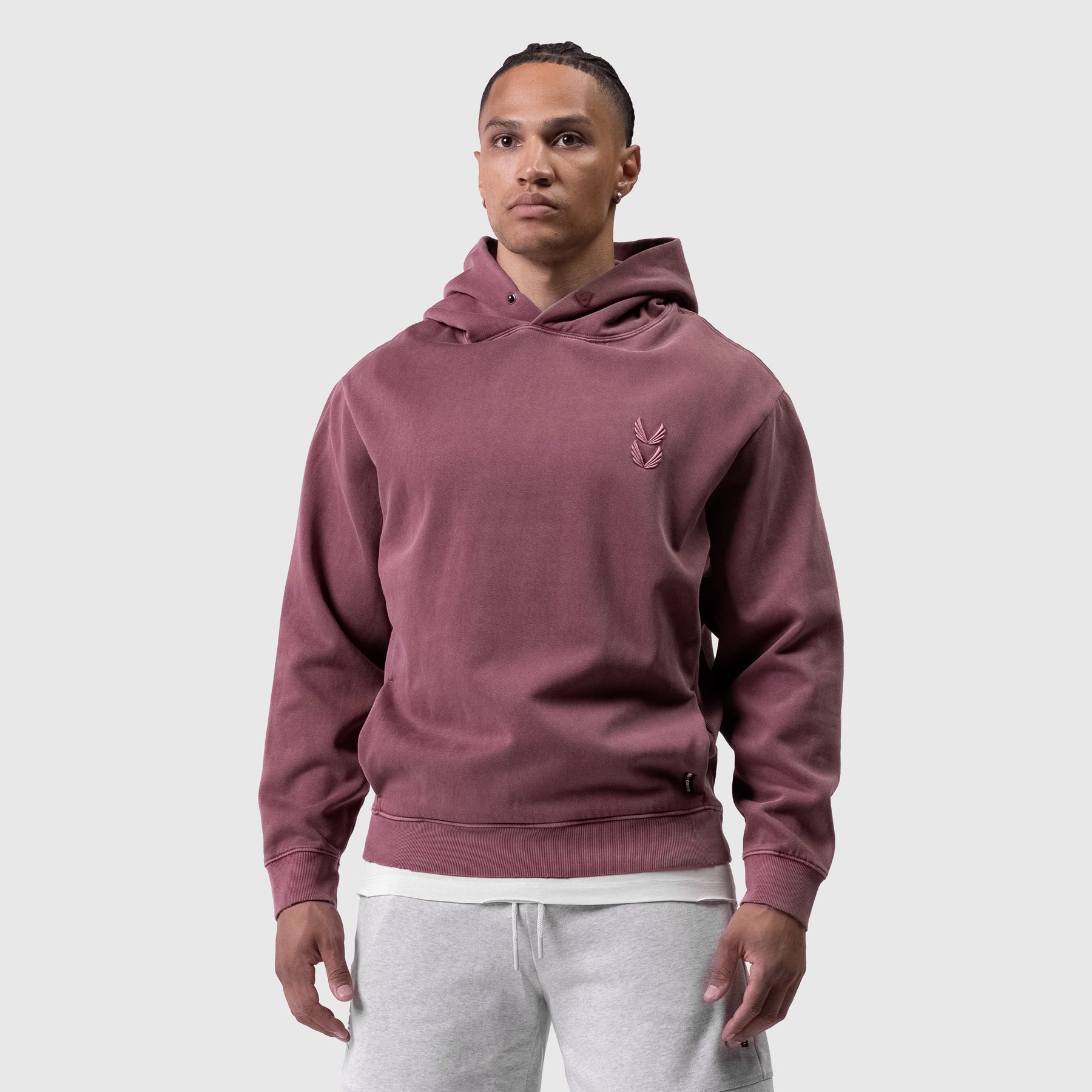 Tech Essential Distressed Hoodie in faded crimson worn by male model, front view