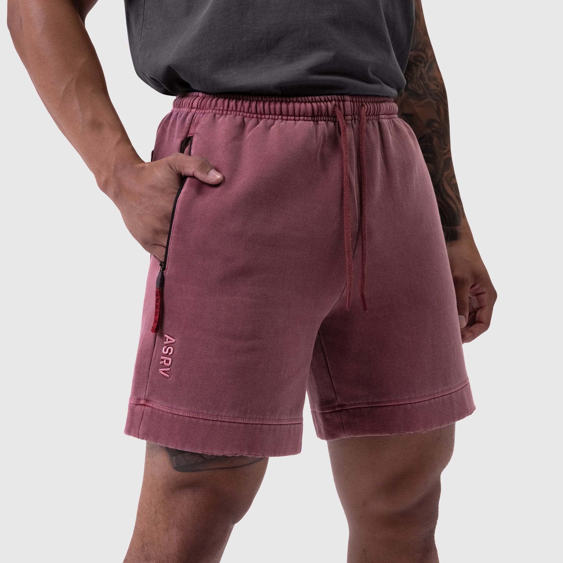 Tech Essential Sweat Short in faded crimson worn by model, side view
