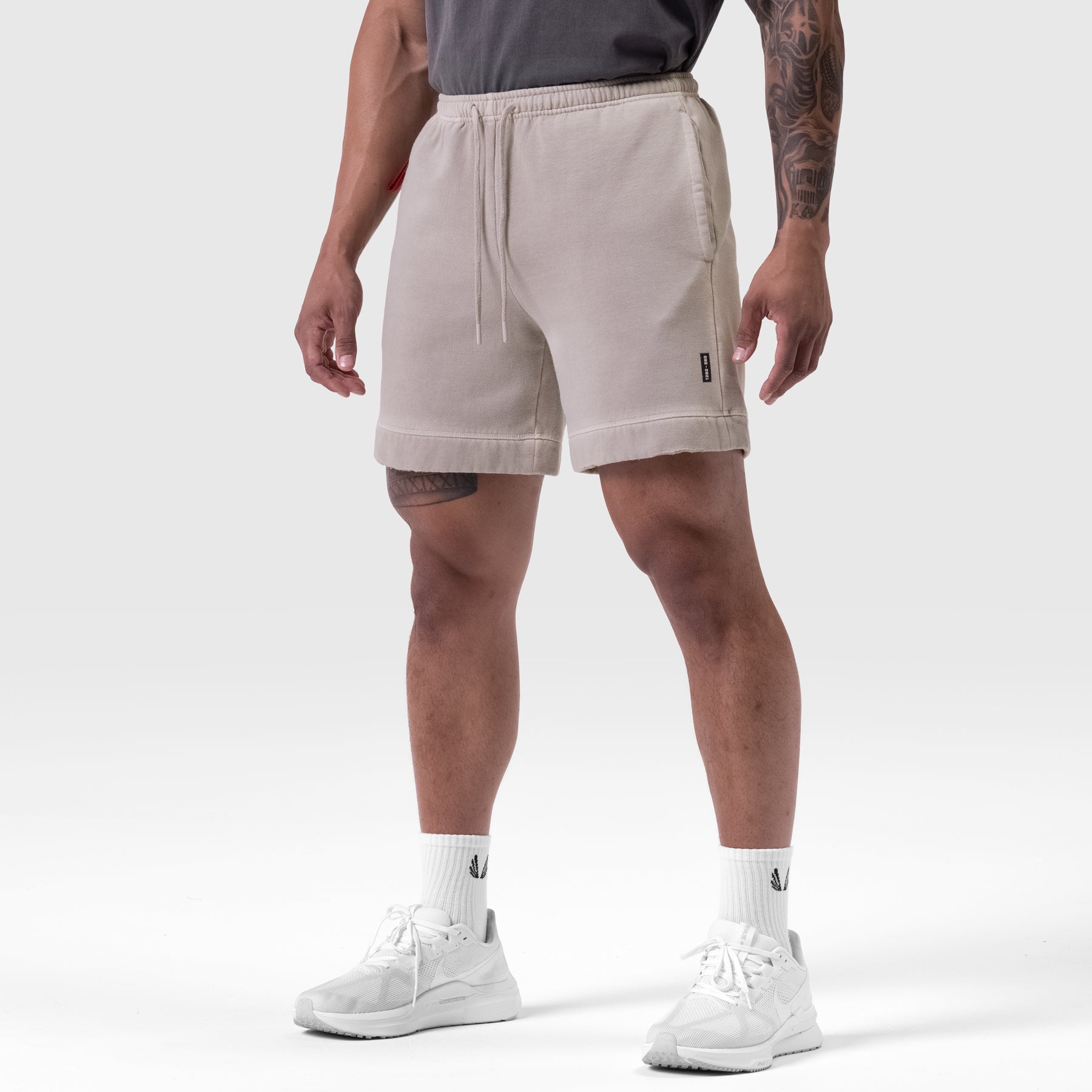 Tech Essential Sweat Short in Faded Chai worn by model, front view