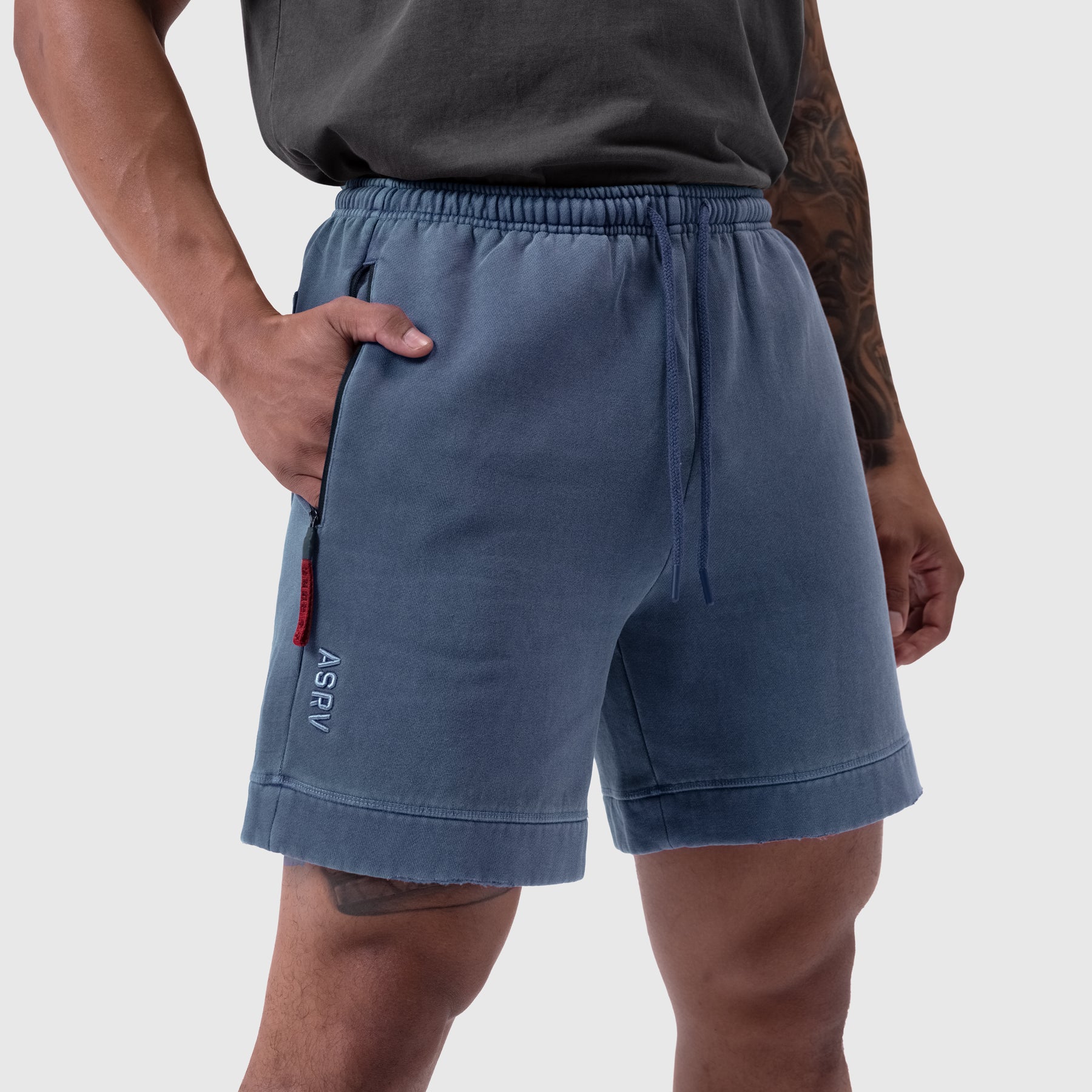 Tech Essential Sweat Short in Faded Navy worn by model, side view