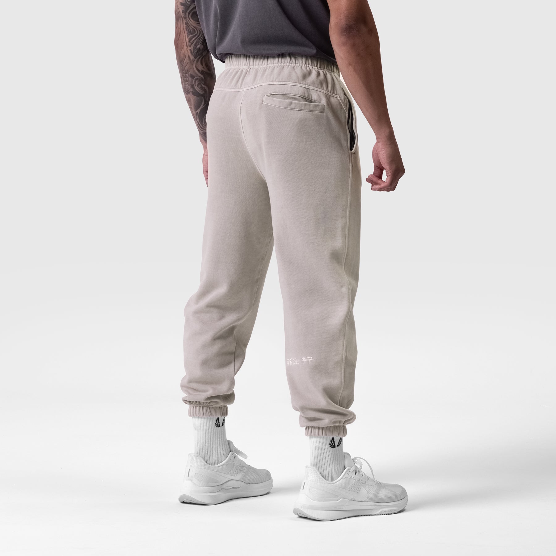 Tech Essential Sweats in Faded Chai worn by model, back view showing jogger silhouette