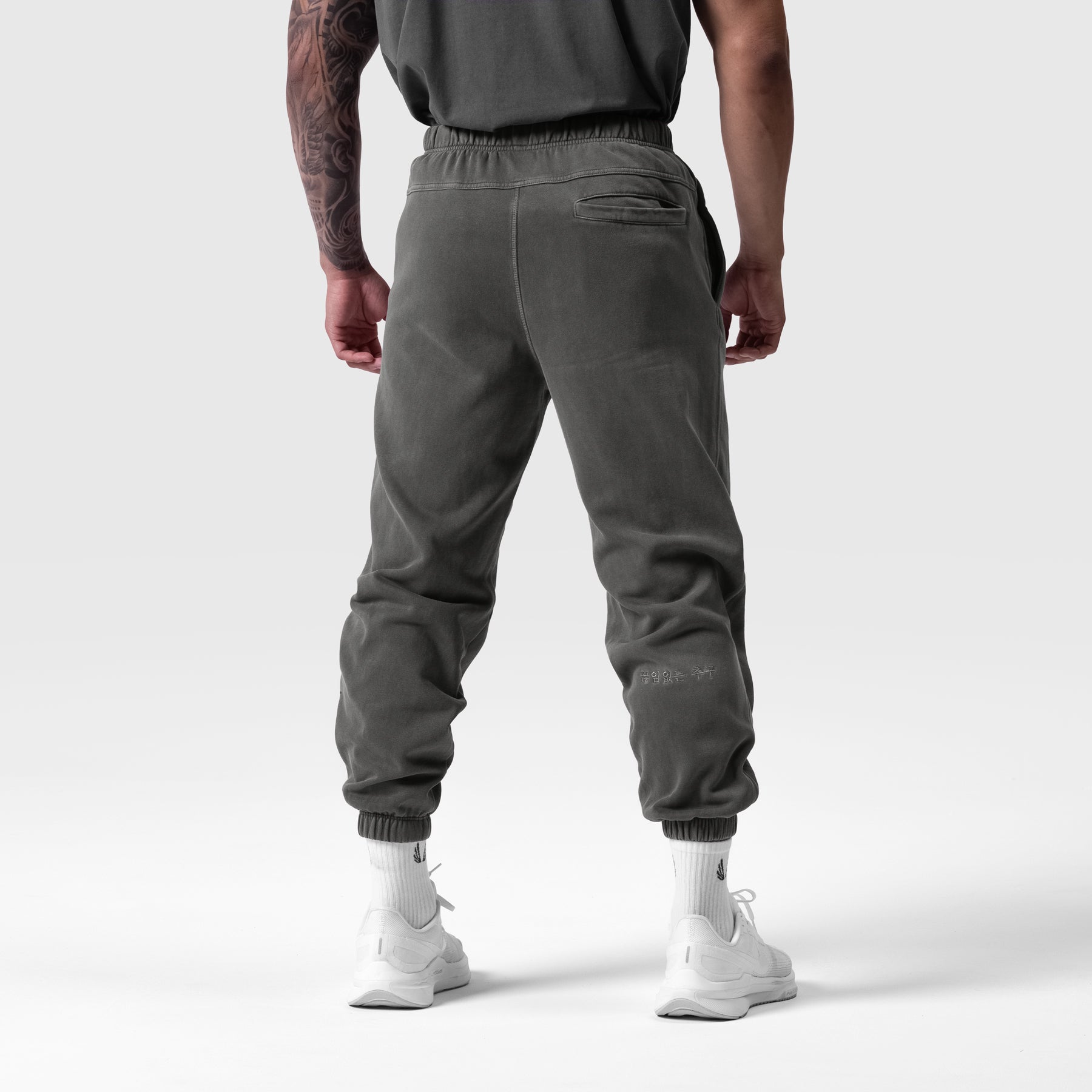 Tech Essential Sweats in faded grey, back view on model with white sneakers