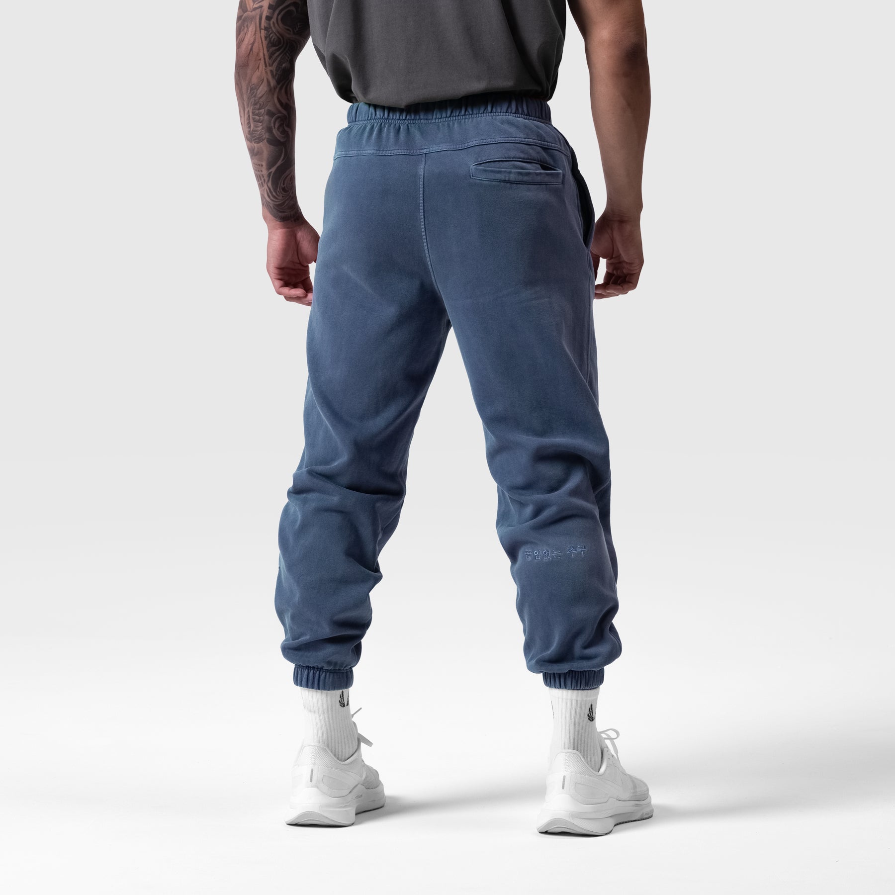 Tech Essential Sweats in faded navy, back view on model wearing white socks and sneakers