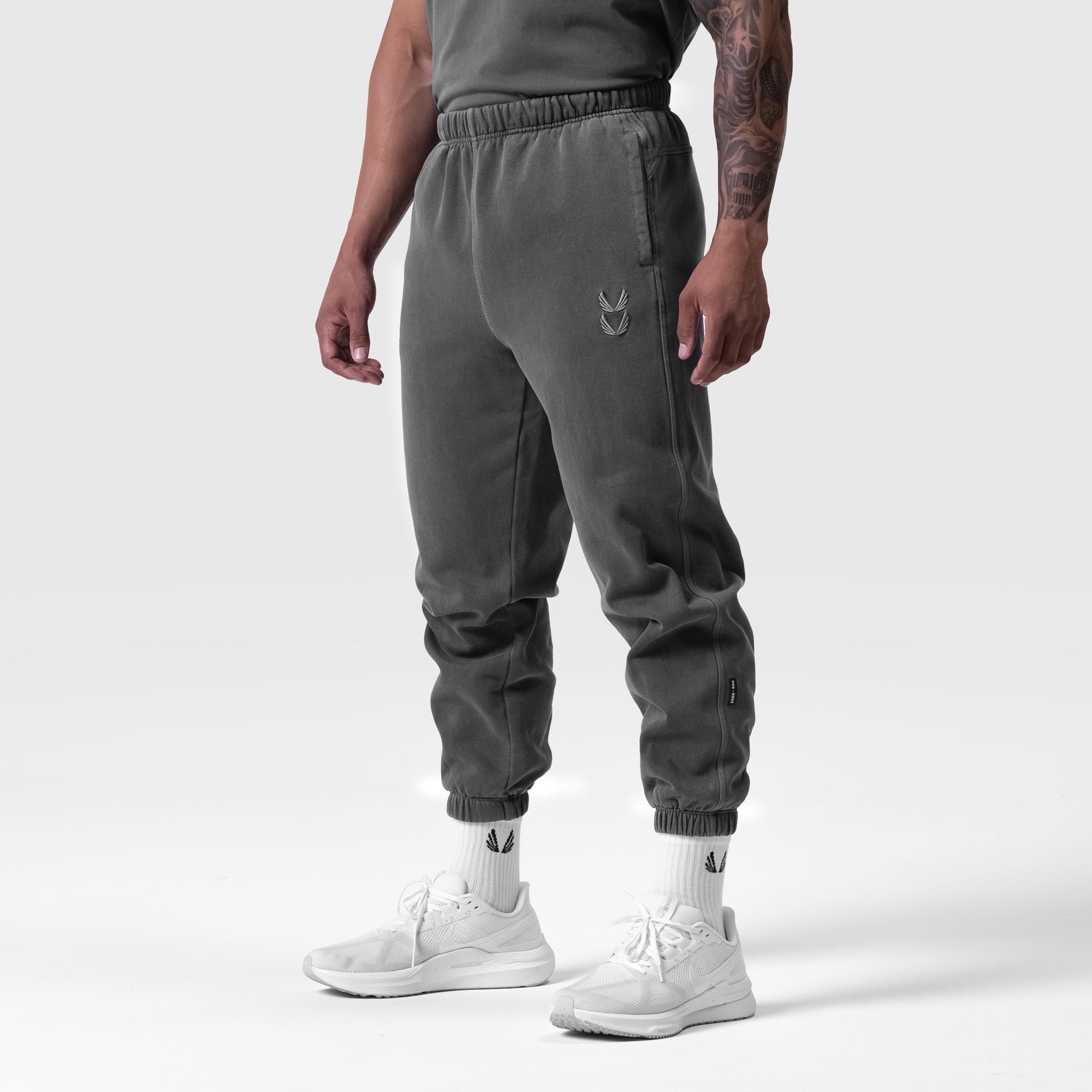 Tech Essential Sweats in faded grey worn by model, cropped jogger view with white socks and sneakers