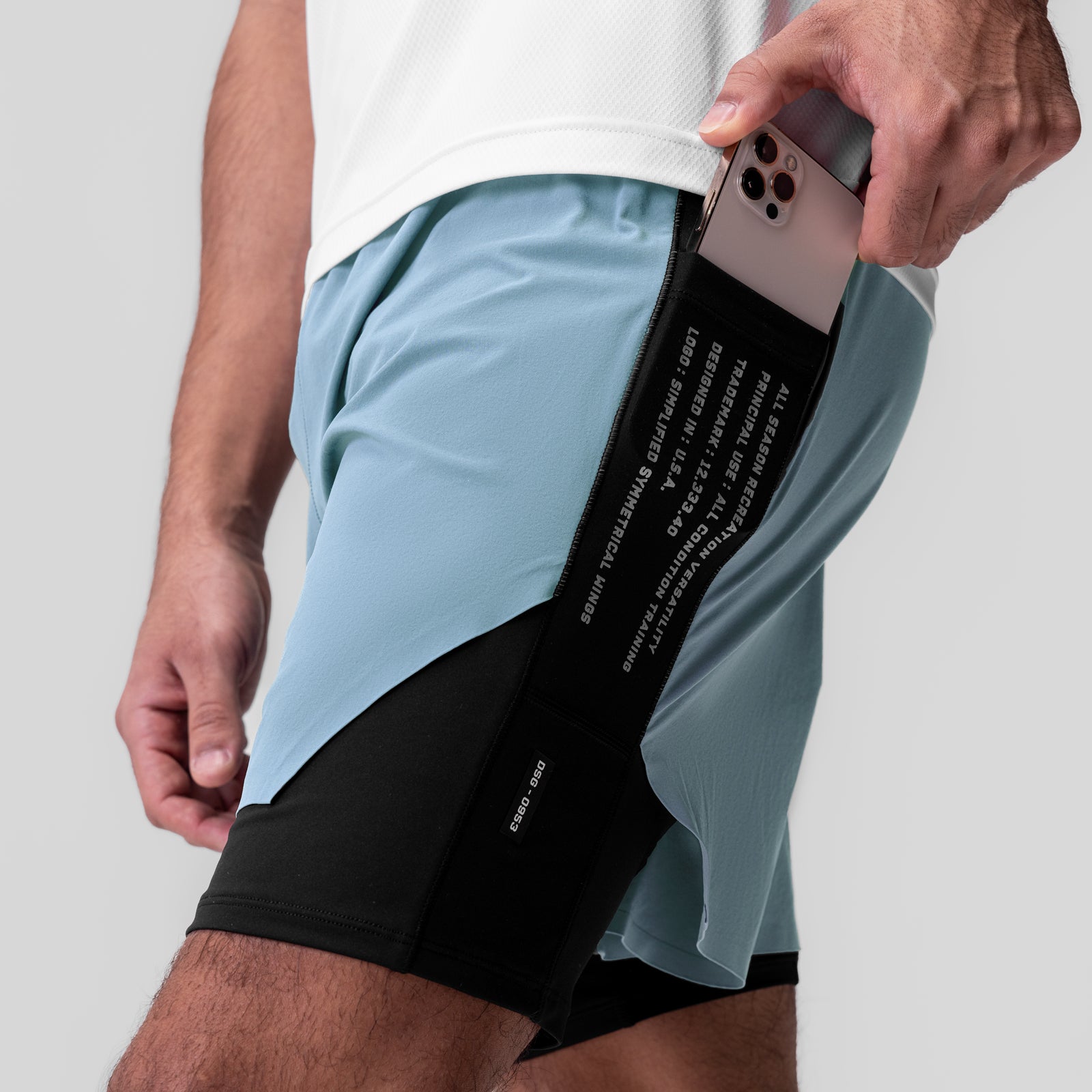 Aerotex™ Hybrid Liner Short in Light Sky/Black, model holding phone in side pocket