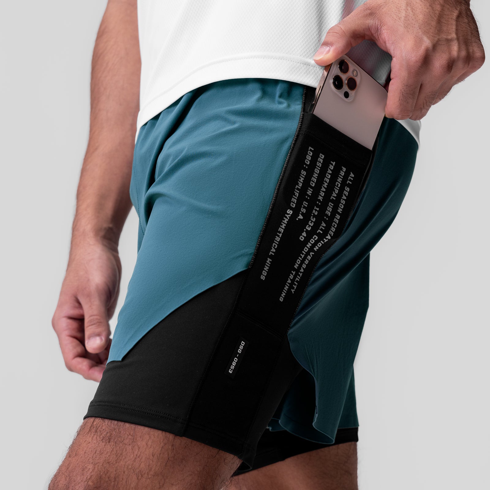 Aerotex Hybrid Liner Short in Storm/Black, model wearing shorts with phone in pocket