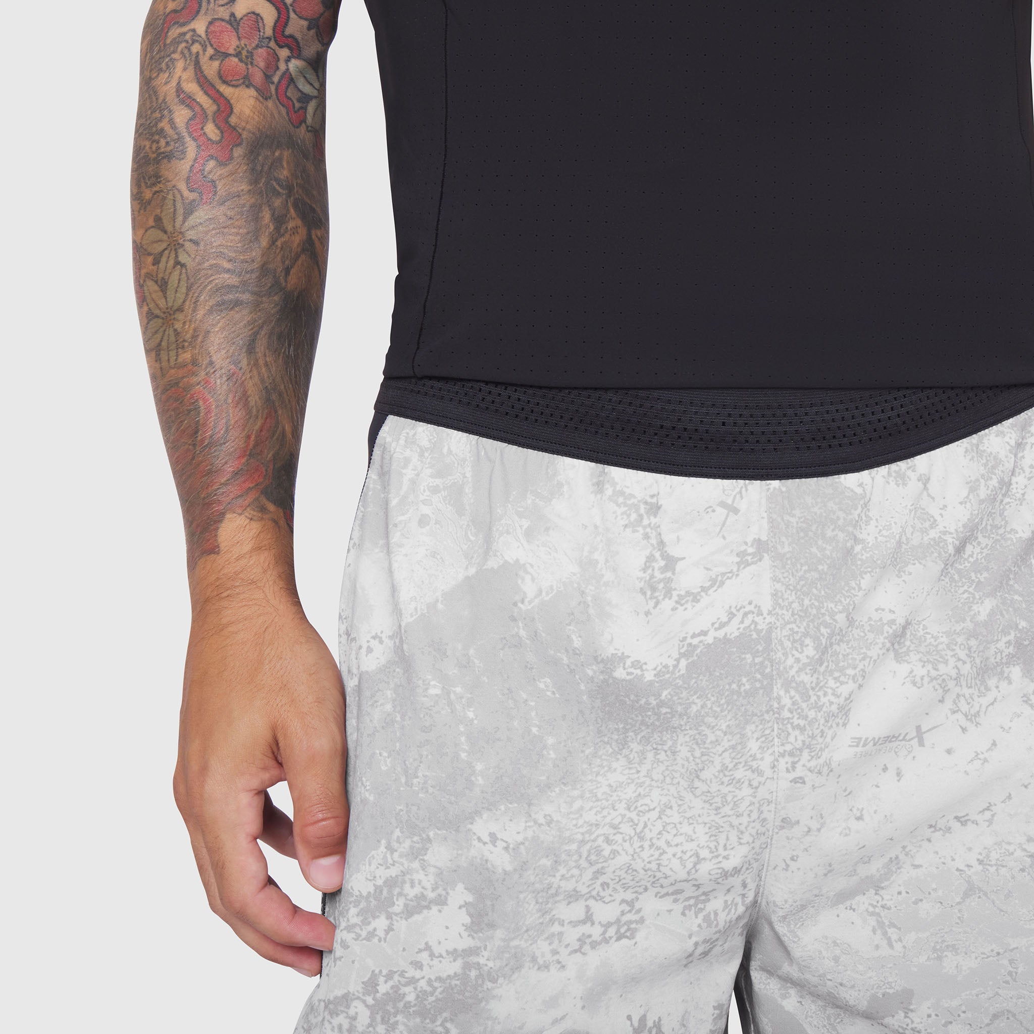 Aerotex™ Hybrid Liner Short in white camo, worn with black top, side view
