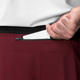 Aerotex Hybrid Liner Short in crimson with black waistband, model pulling out white liner detail