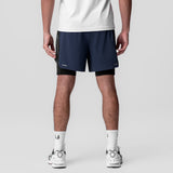Aerotex Hybrid Liner Short in navy and black worn by model, rear view