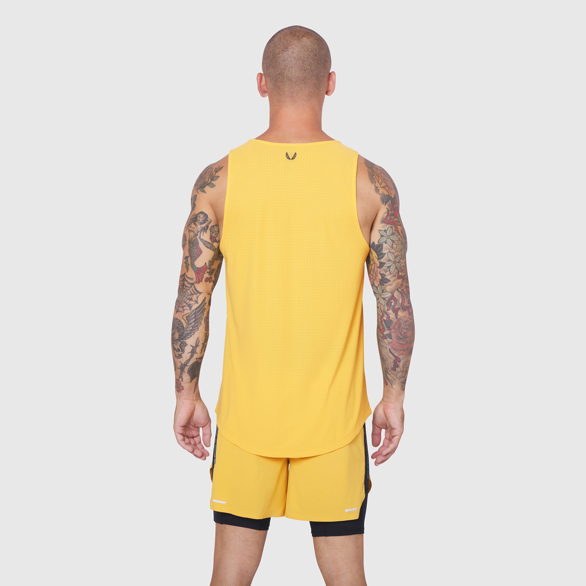 Laser-Vent Tank Top in amber yellow worn by model, back view