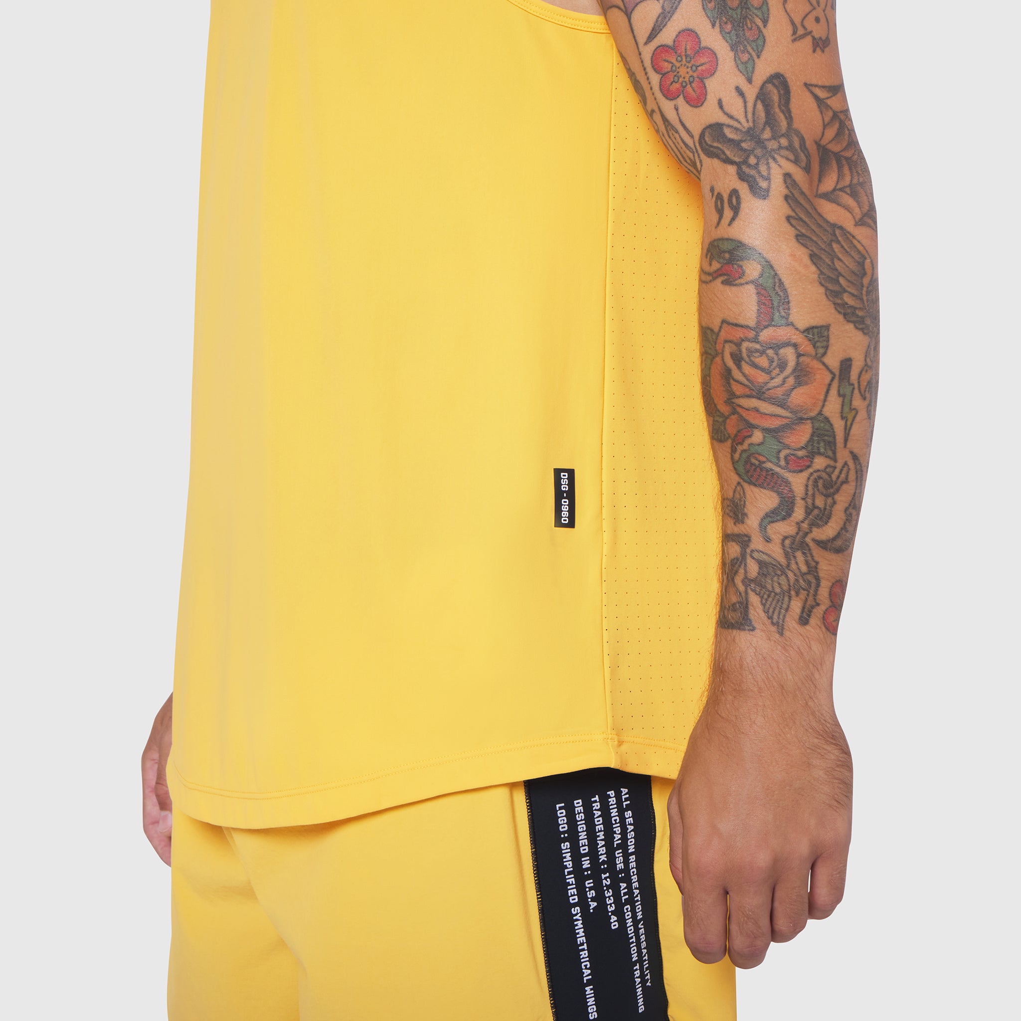 Laser-Vent Tank Top in amber yellow worn by model showing side view and fit
