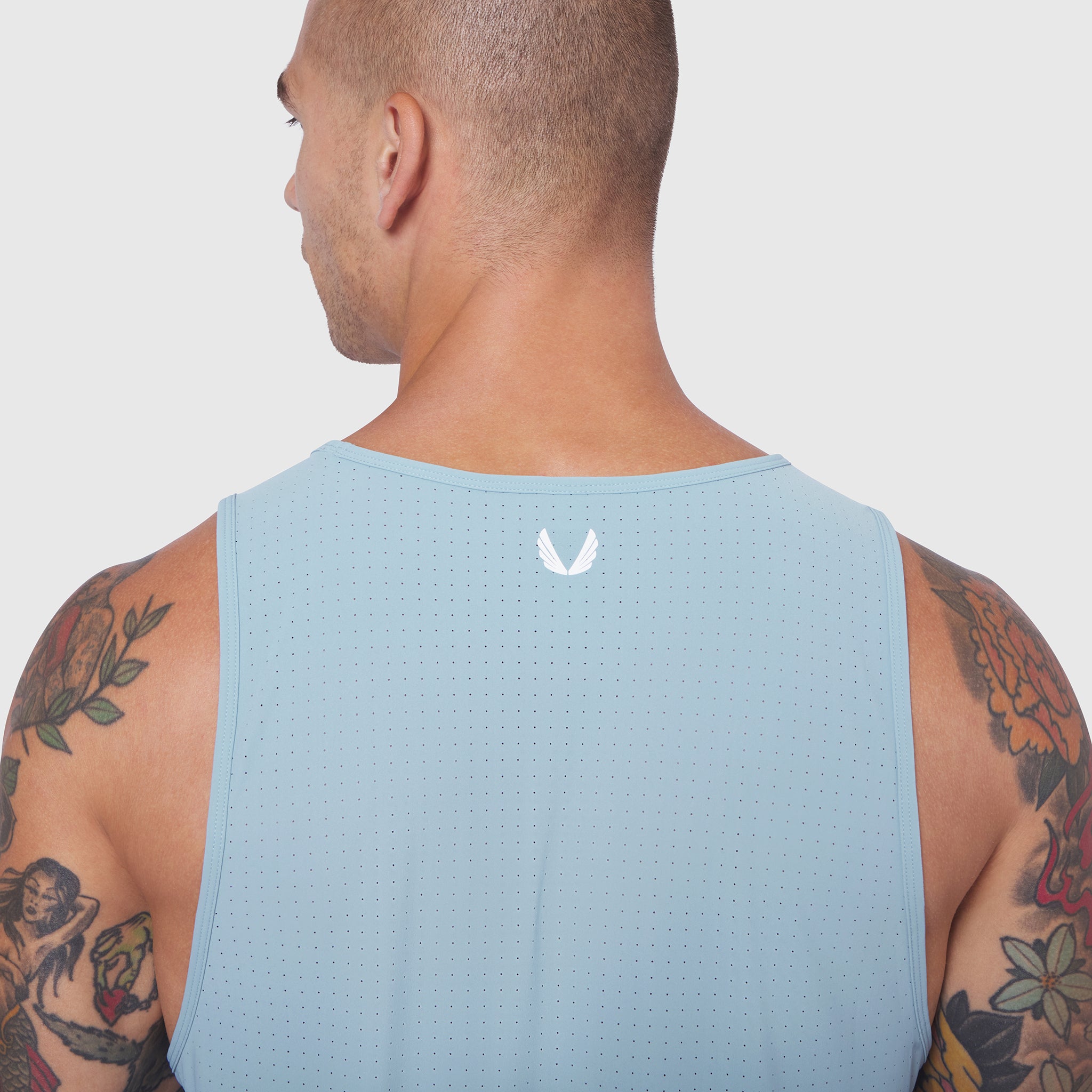 Laser-Vent™ Tank Top in Light Sky, back view on model with tattoos