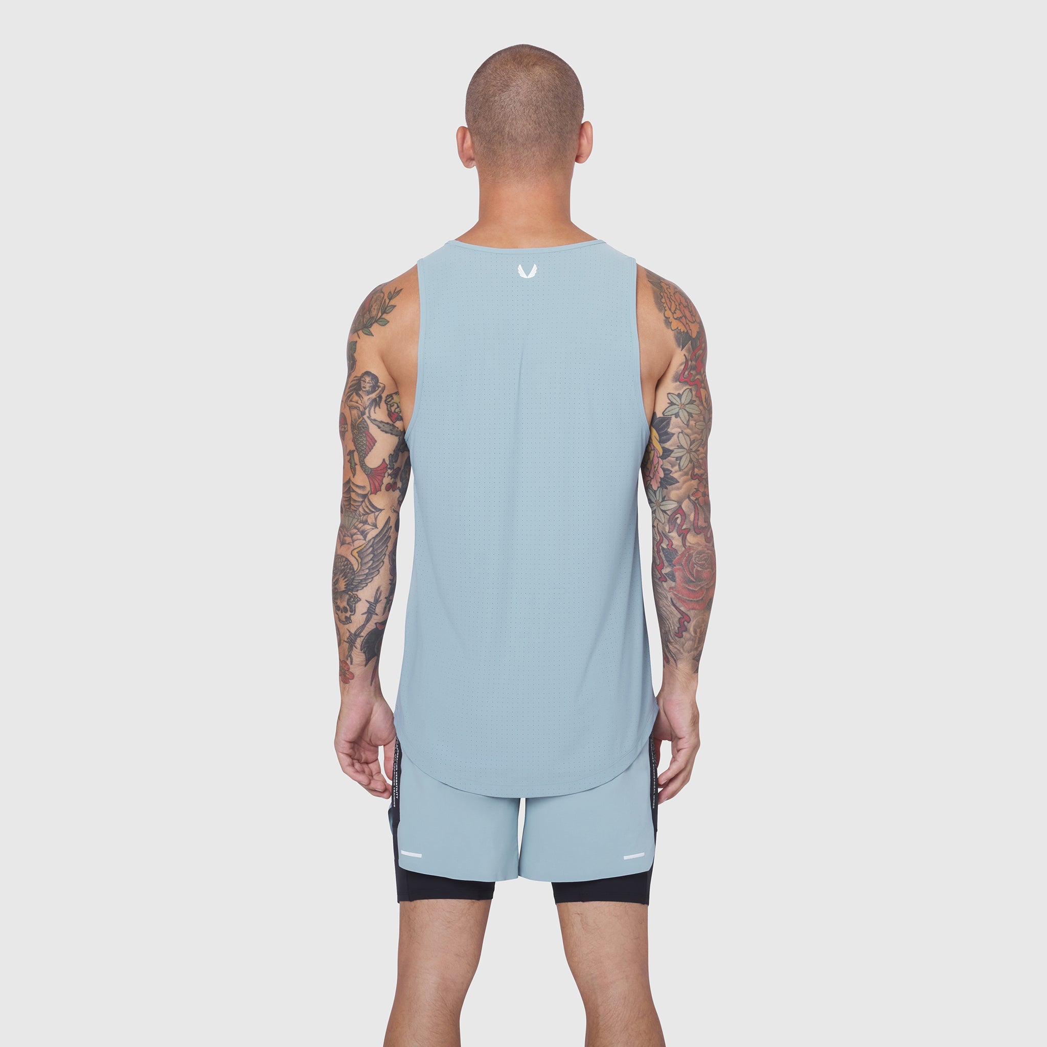 Laser-Vent Tank Top in light sky, worn by model from back, paired with black shorts