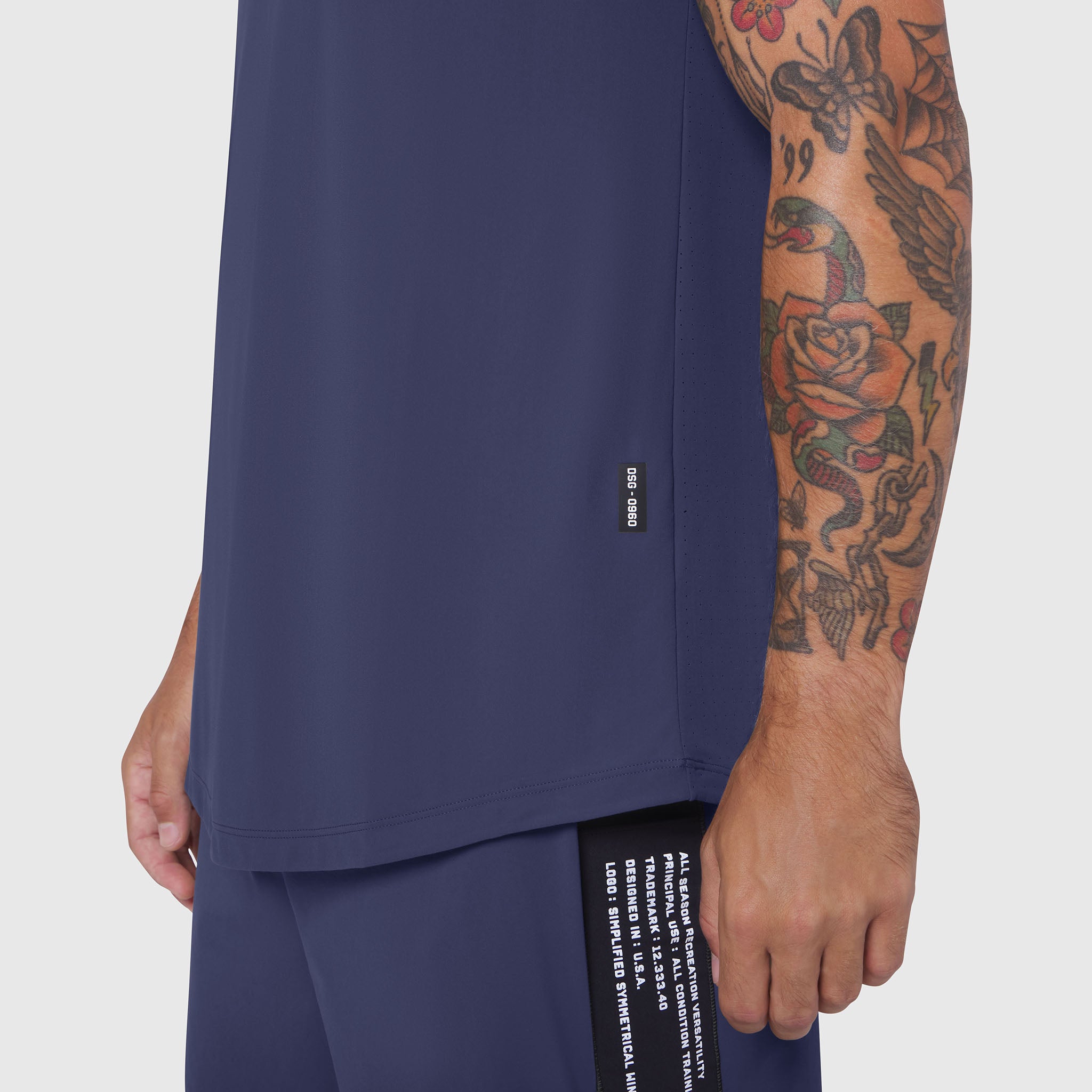 Laser-Vent™ Tank Top in navy worn by model, side view showing fit and branding details