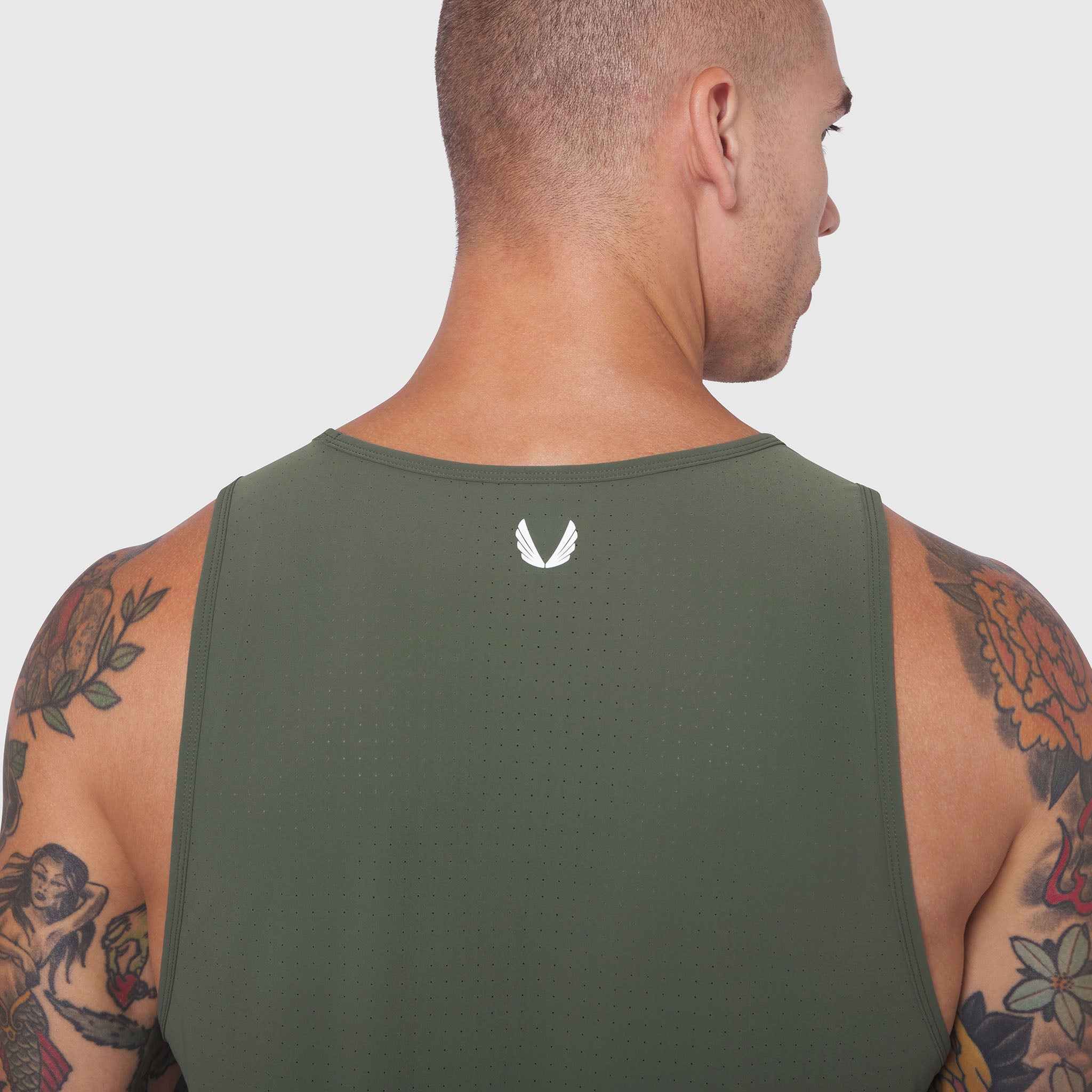 Laser-Vent Tank Top in olive worn by male model showing back view with perforated fabric detail