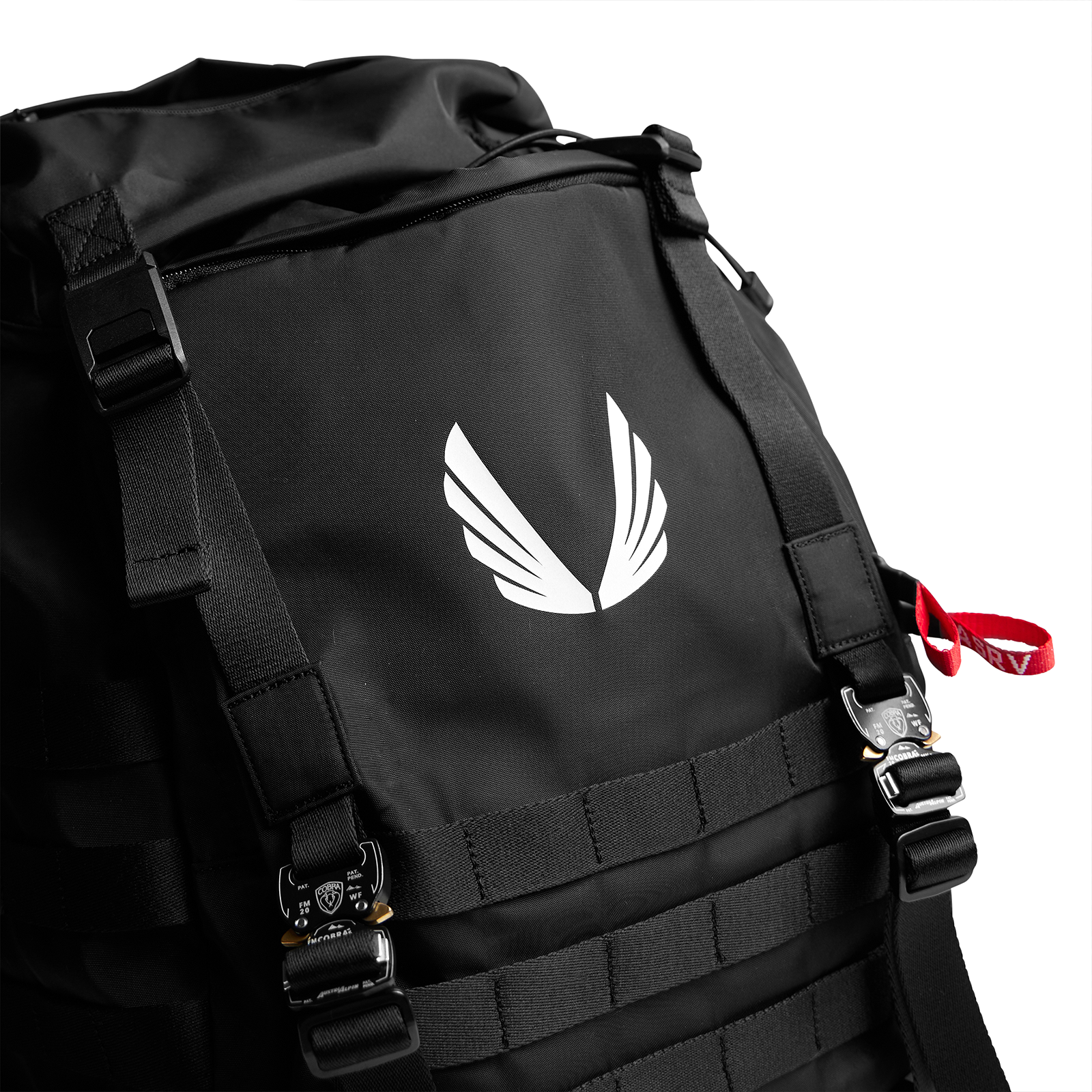 Waterproof MOLLE Backpack in black, carried on shoulder with white wing logo visible