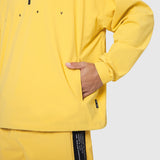 Aerotex Quarter-Zip Jacket in amber yellow worn by model with hand in pocket