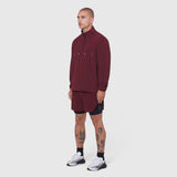 Aerotex Quarter-Zip Jacket in crimson worn by model with matching shorts, side view