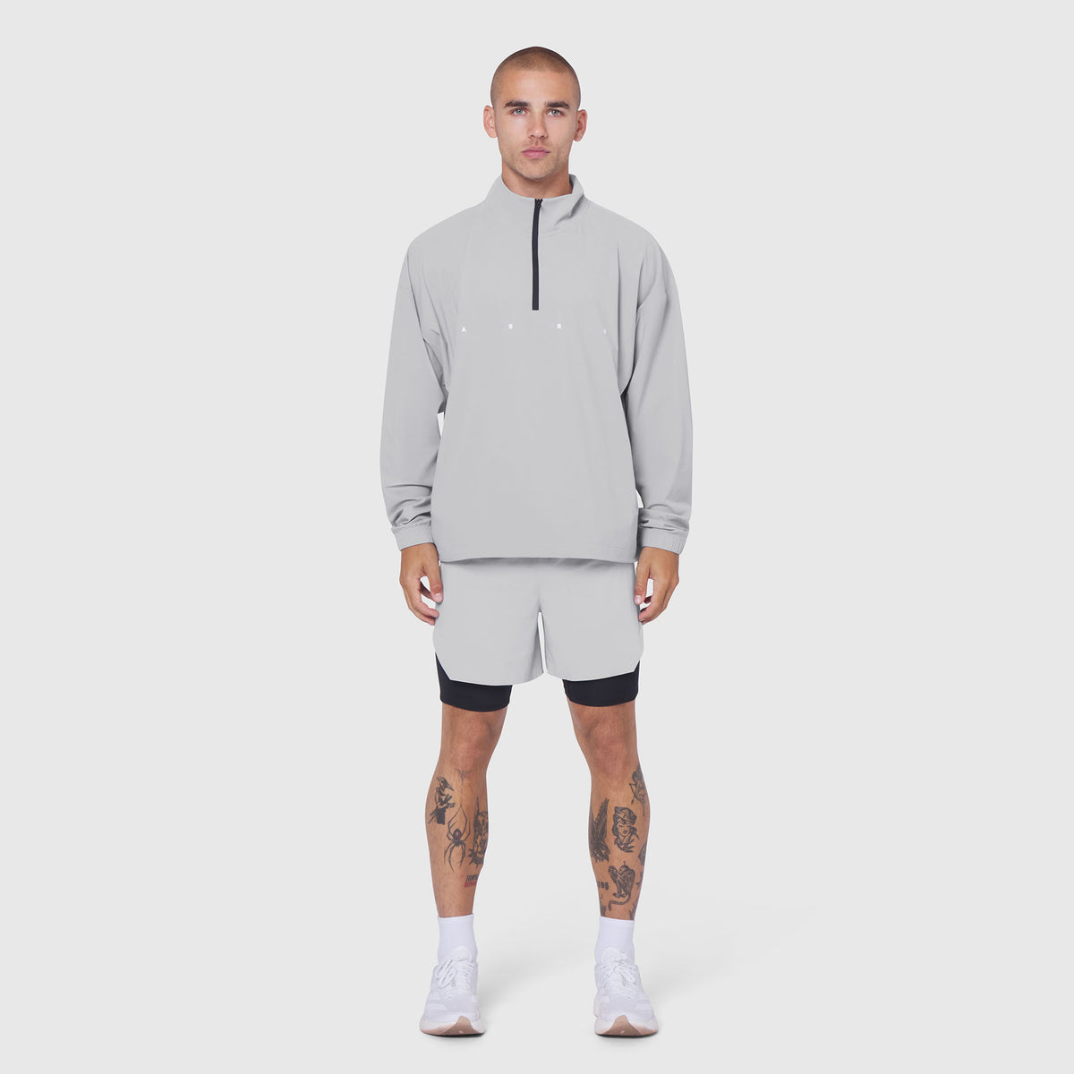 Aerotex Quarter-Zip Jacket in slate grey worn with matching shorts, front view on model