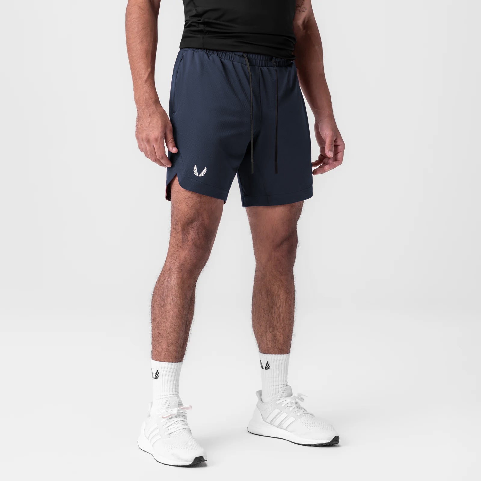 AeroSilver 7" Linerless Short in navy, worn by model with white socks and sneakers
