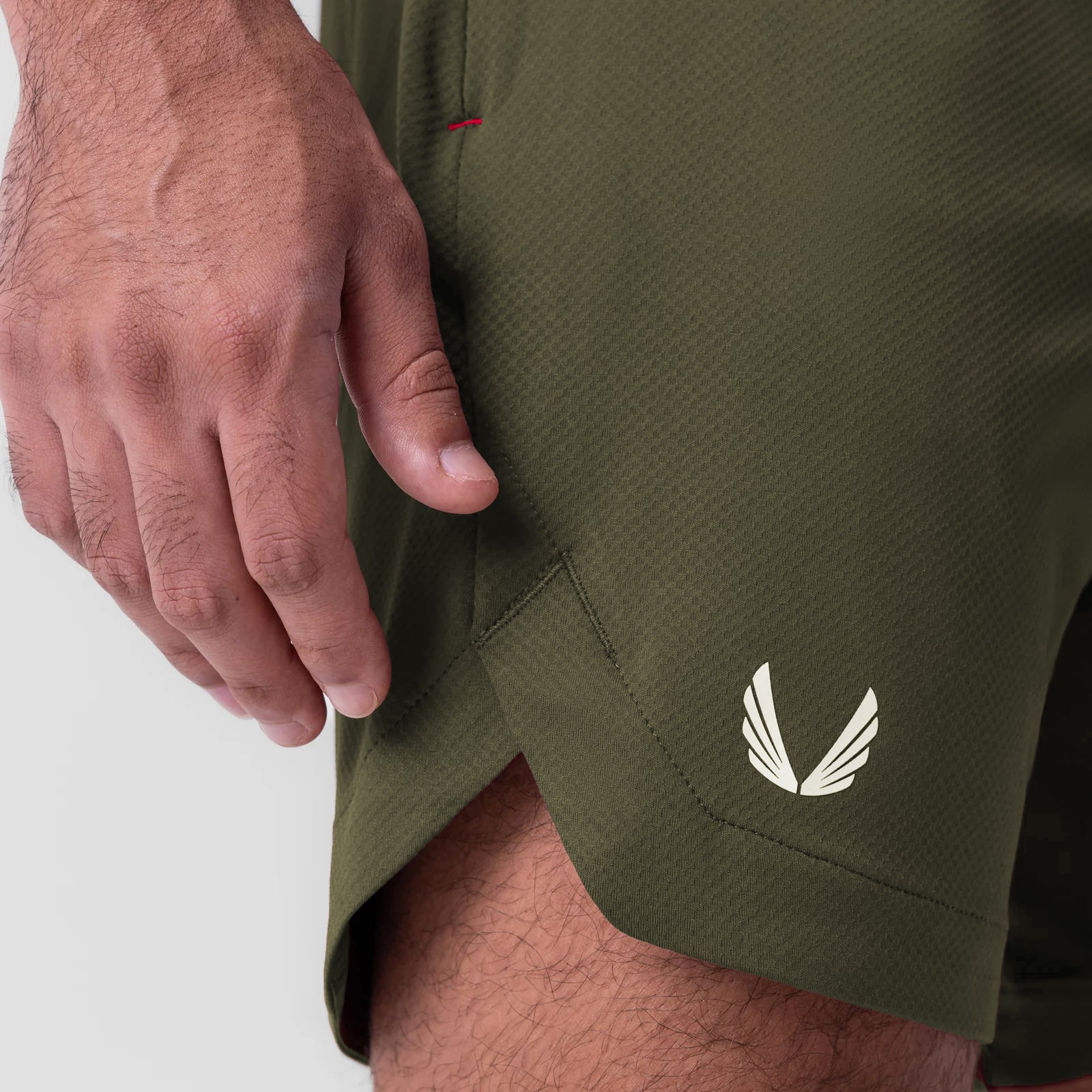 AeroSilver 7" Linerless Short in olive, worn by model showing side pocket detail