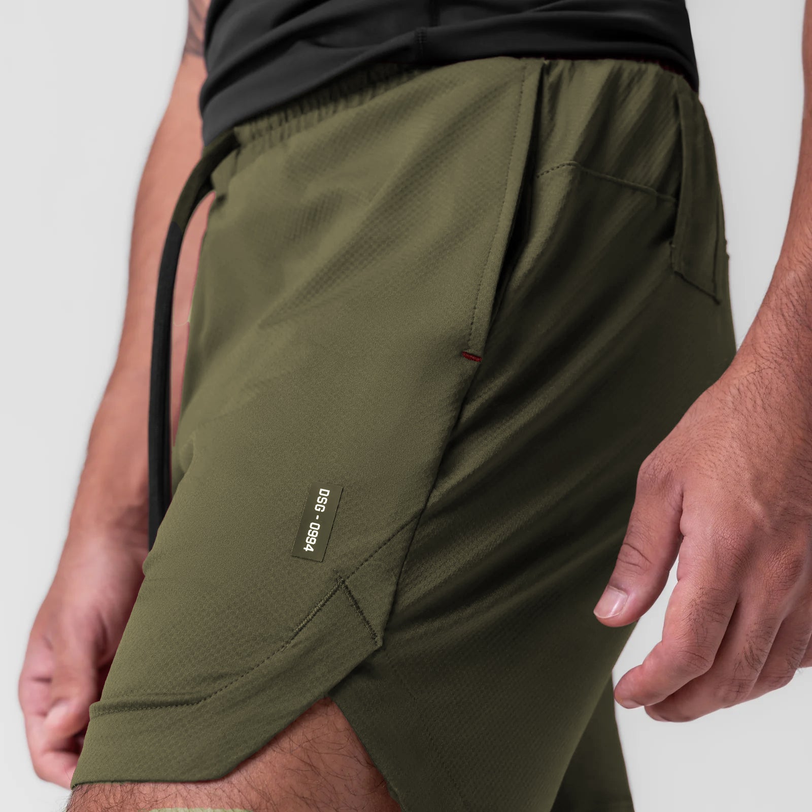 AeroSilver 7" Linerless Short in olive worn by model, side view detail
