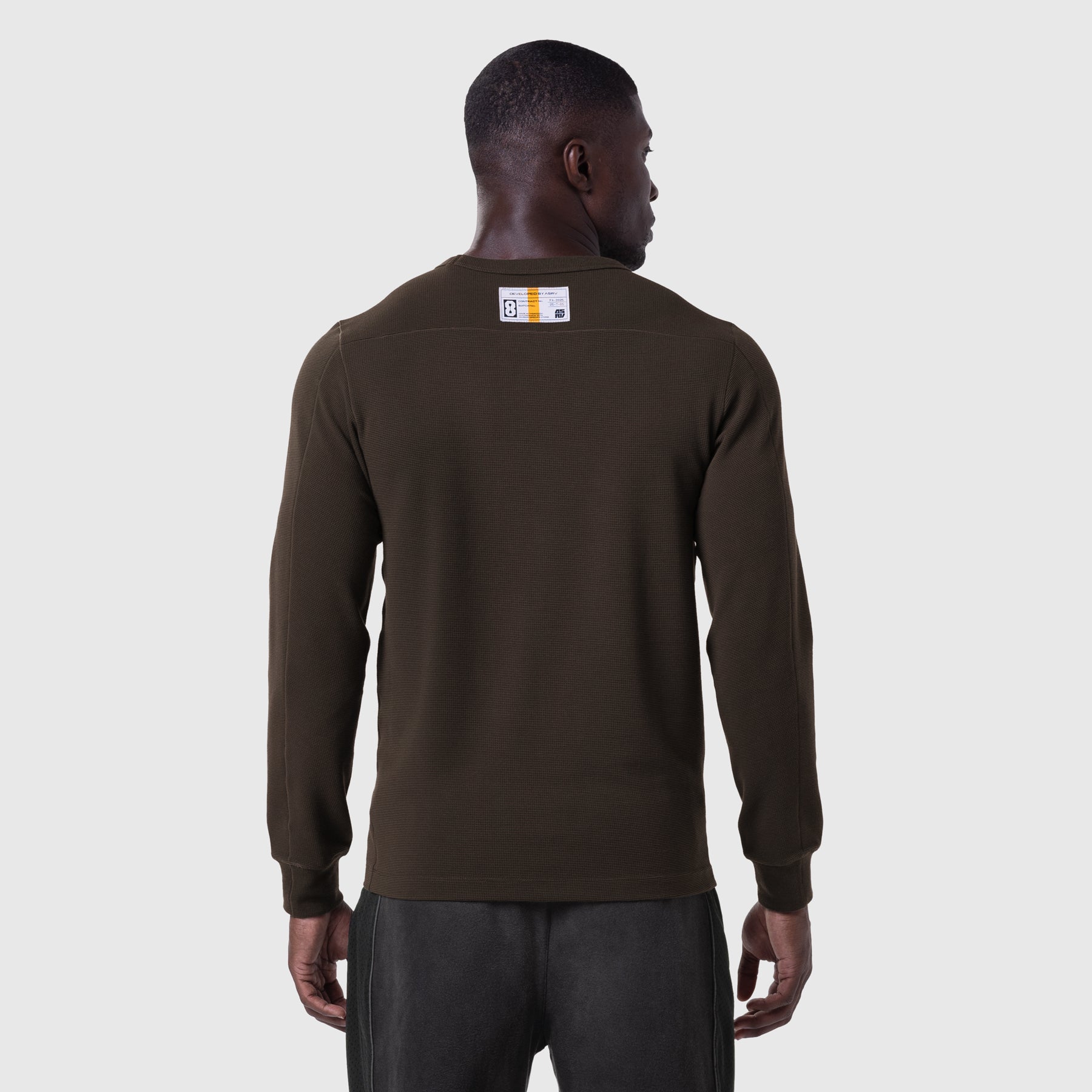 Dark earth waffle knit longsleeve worn by model, back view