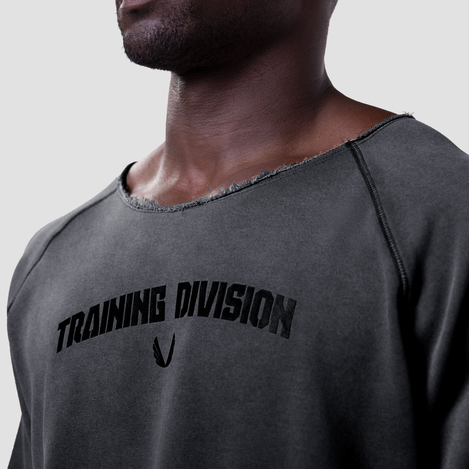 Vintage Raw Hem Pump Cover in charcoal grey worn by model, chest view showing 'Training Division' text